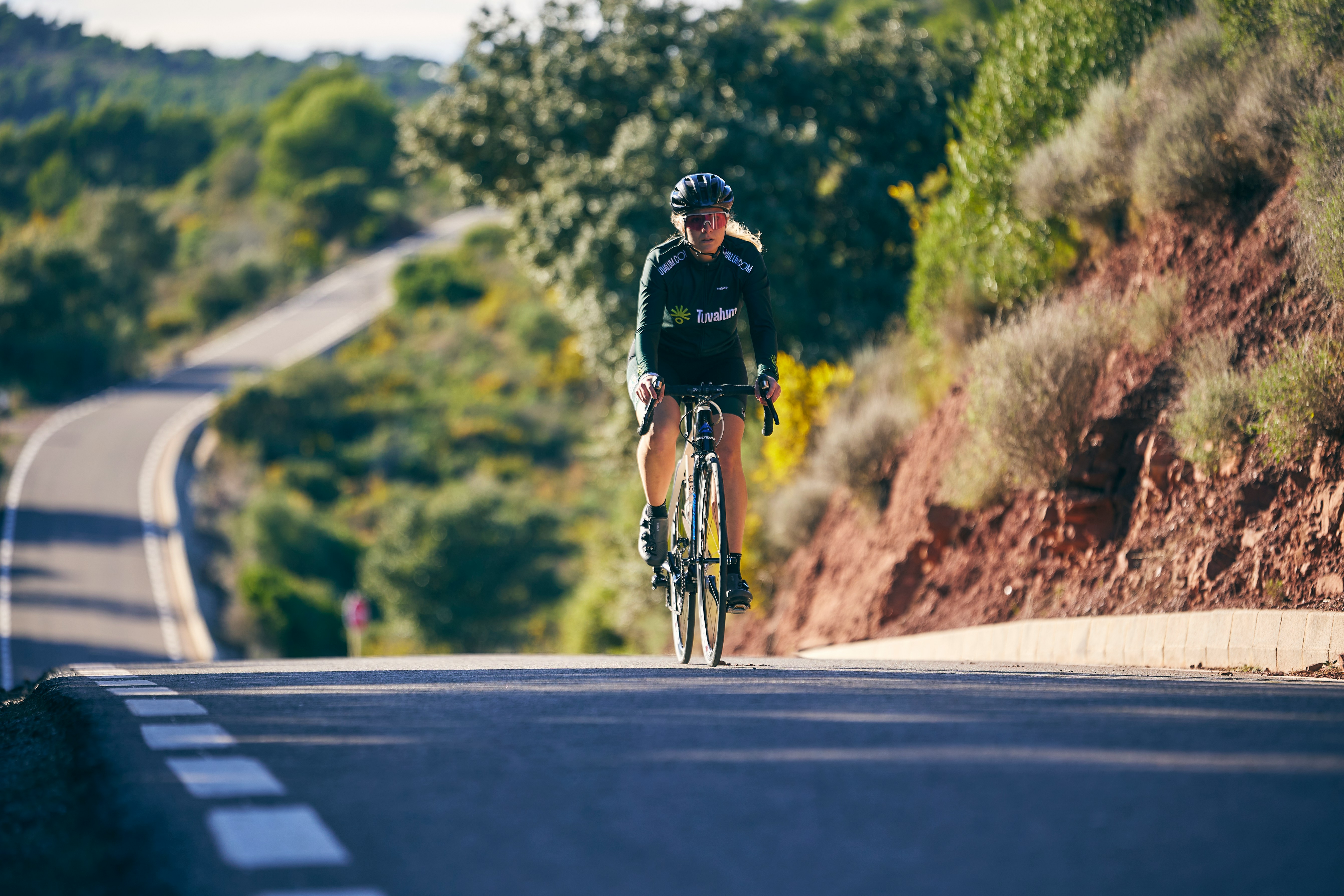 Cyclist riding a road bike outdoors in real conditions.