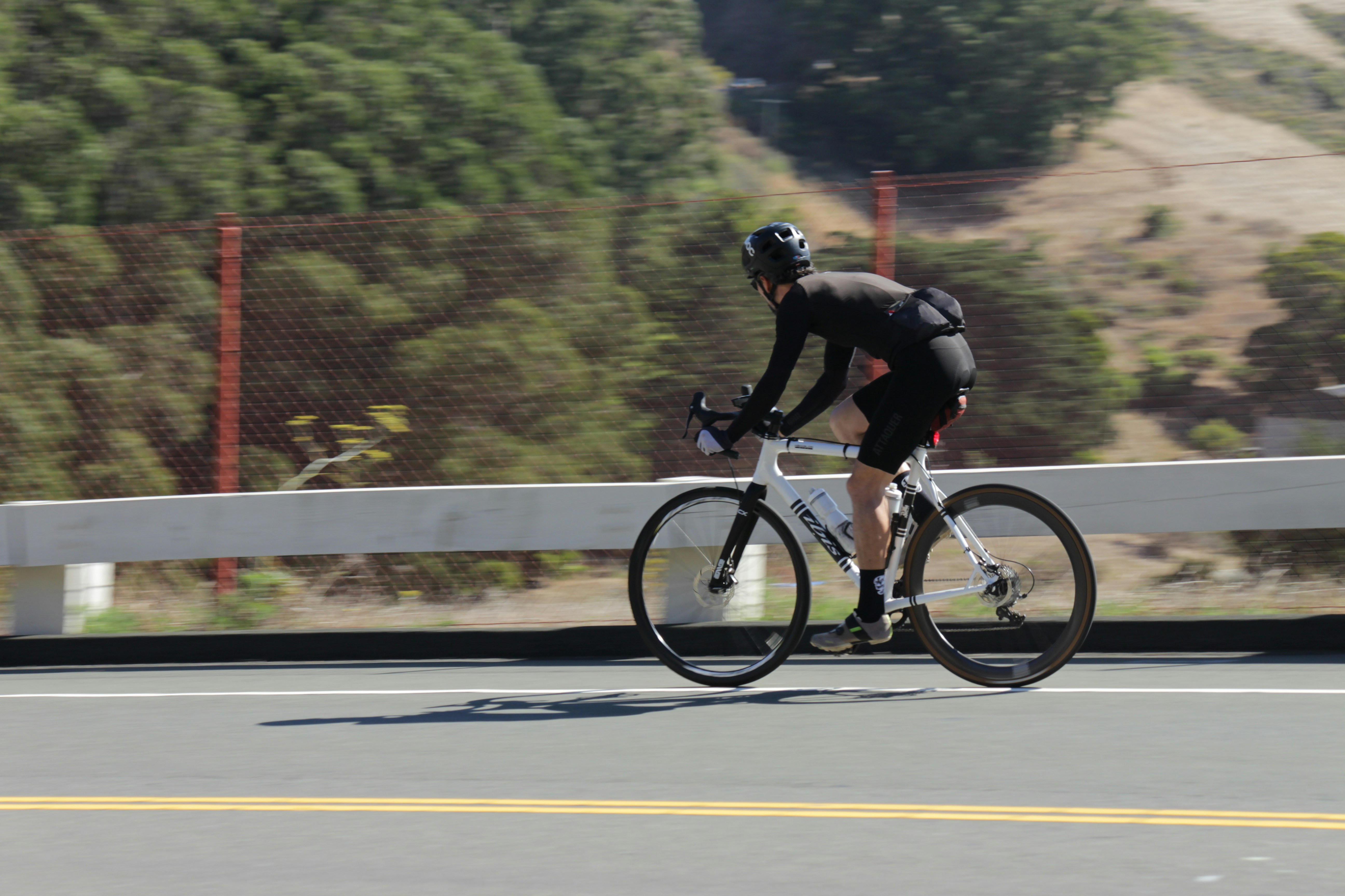 Cyclist riding a road bike outdoors in real conditions.
