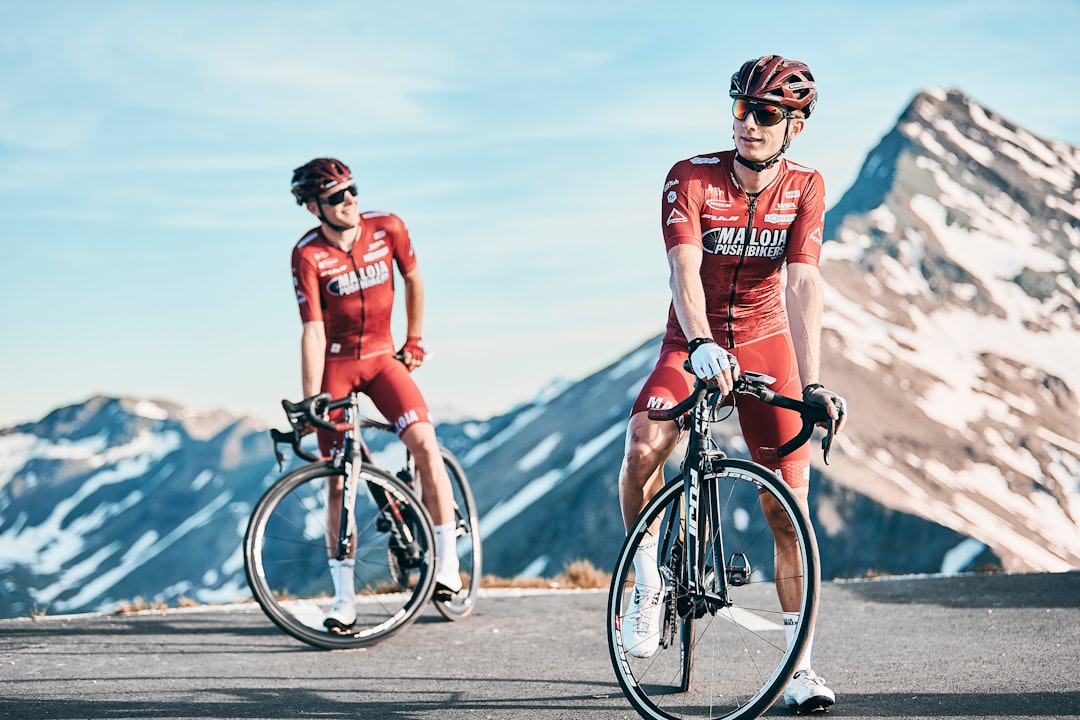 Group of road cyclists riding together outdoors on paved roads.