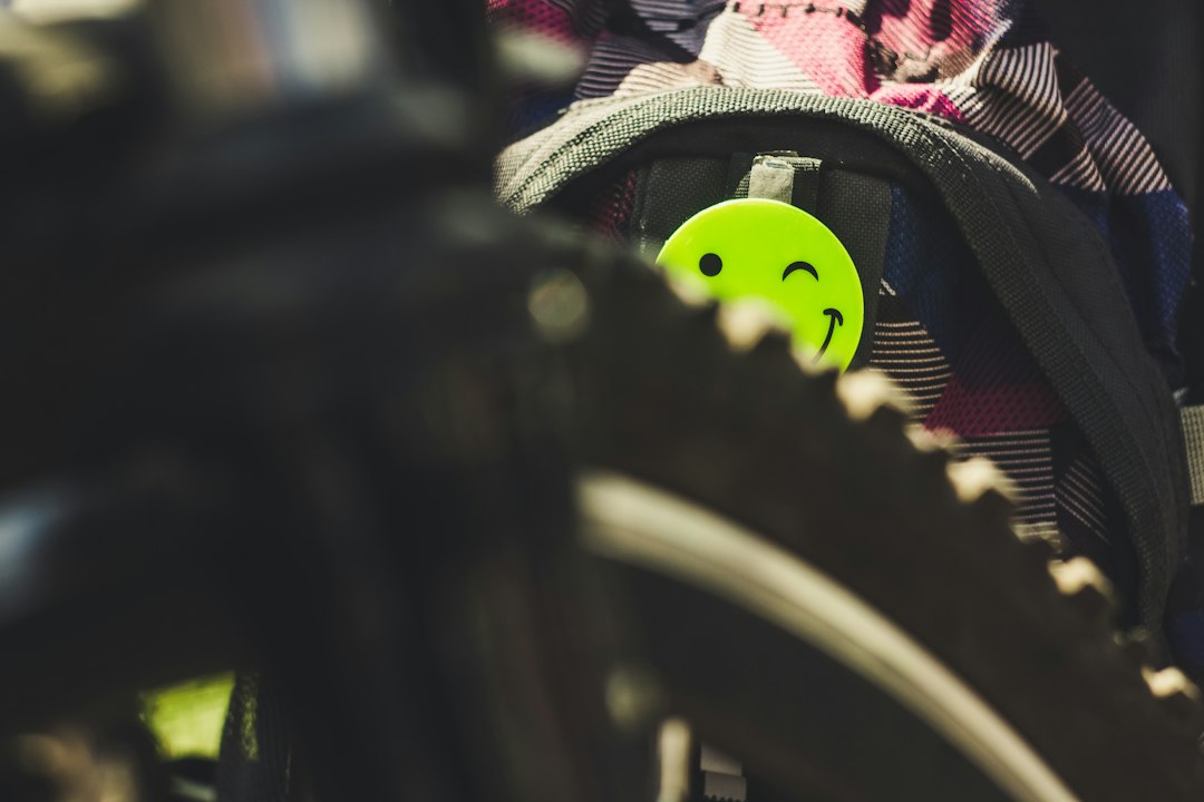 Close-up of a cyclist pedaling on a road bike with a power meter visible.