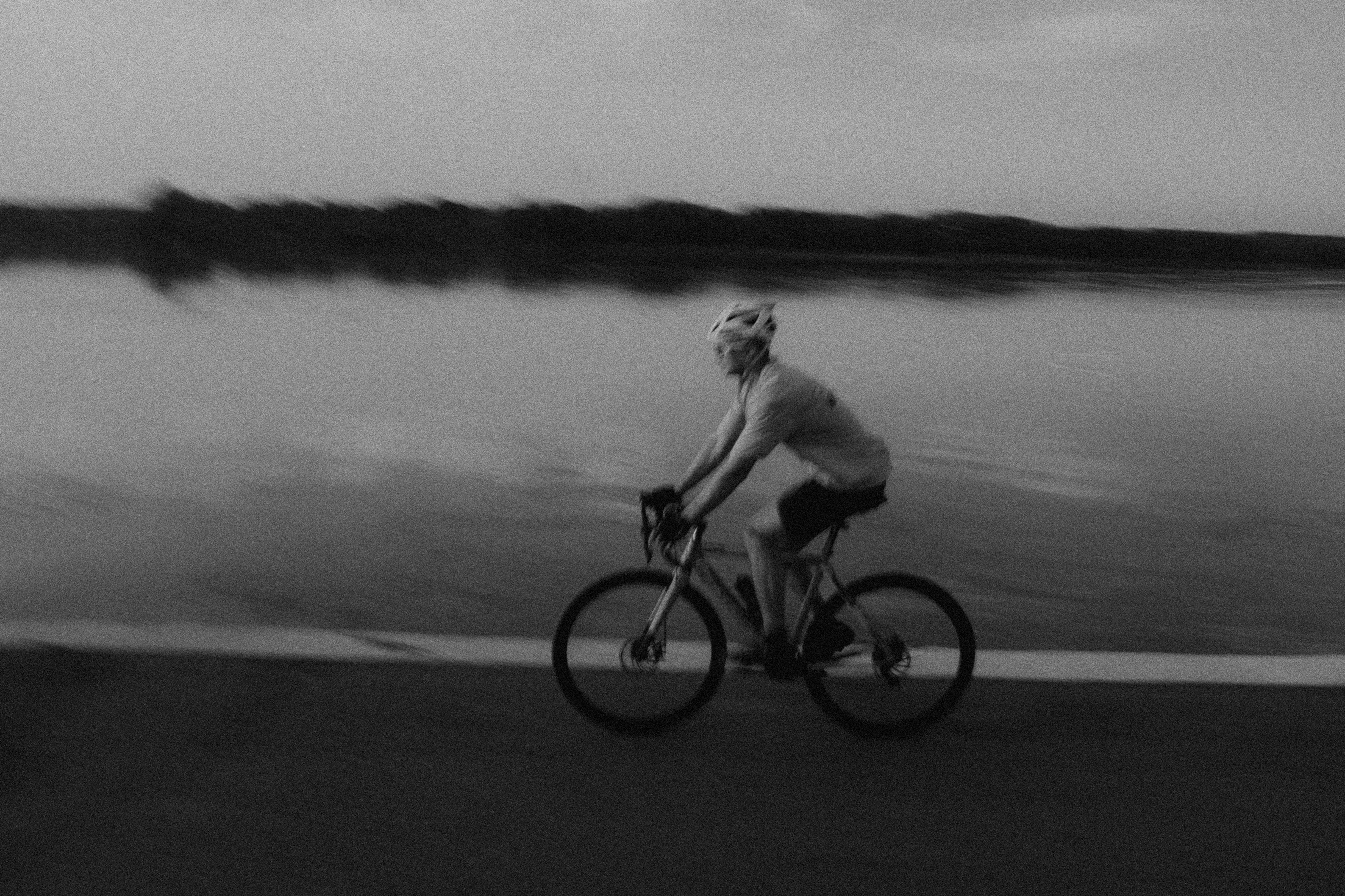 Cyclist riding a road bike outdoors in real conditions.