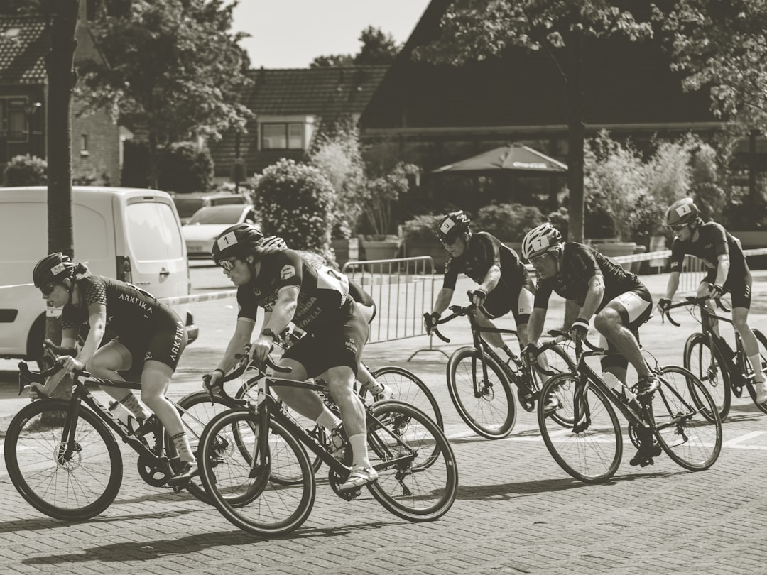 Group of road cyclists riding together outdoors on paved roads.