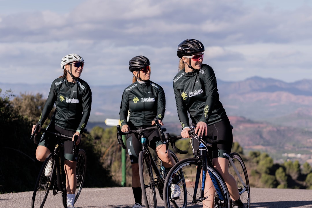 Group of road cyclists riding together outdoors on paved roads.