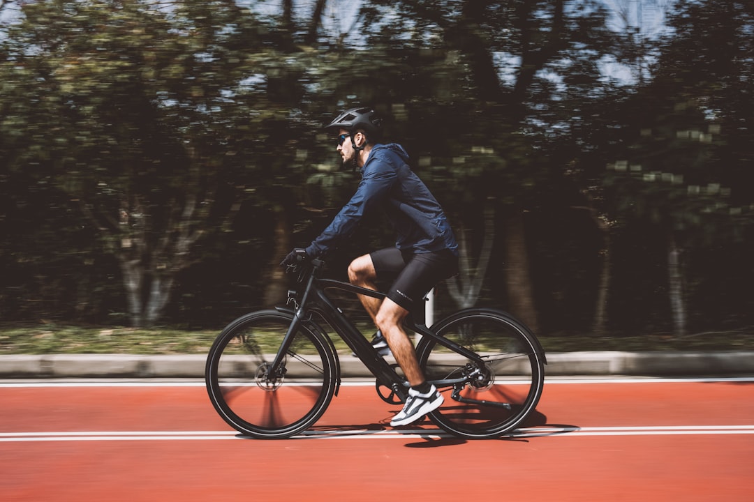 Group of road cyclists riding together outdoors on paved roads.