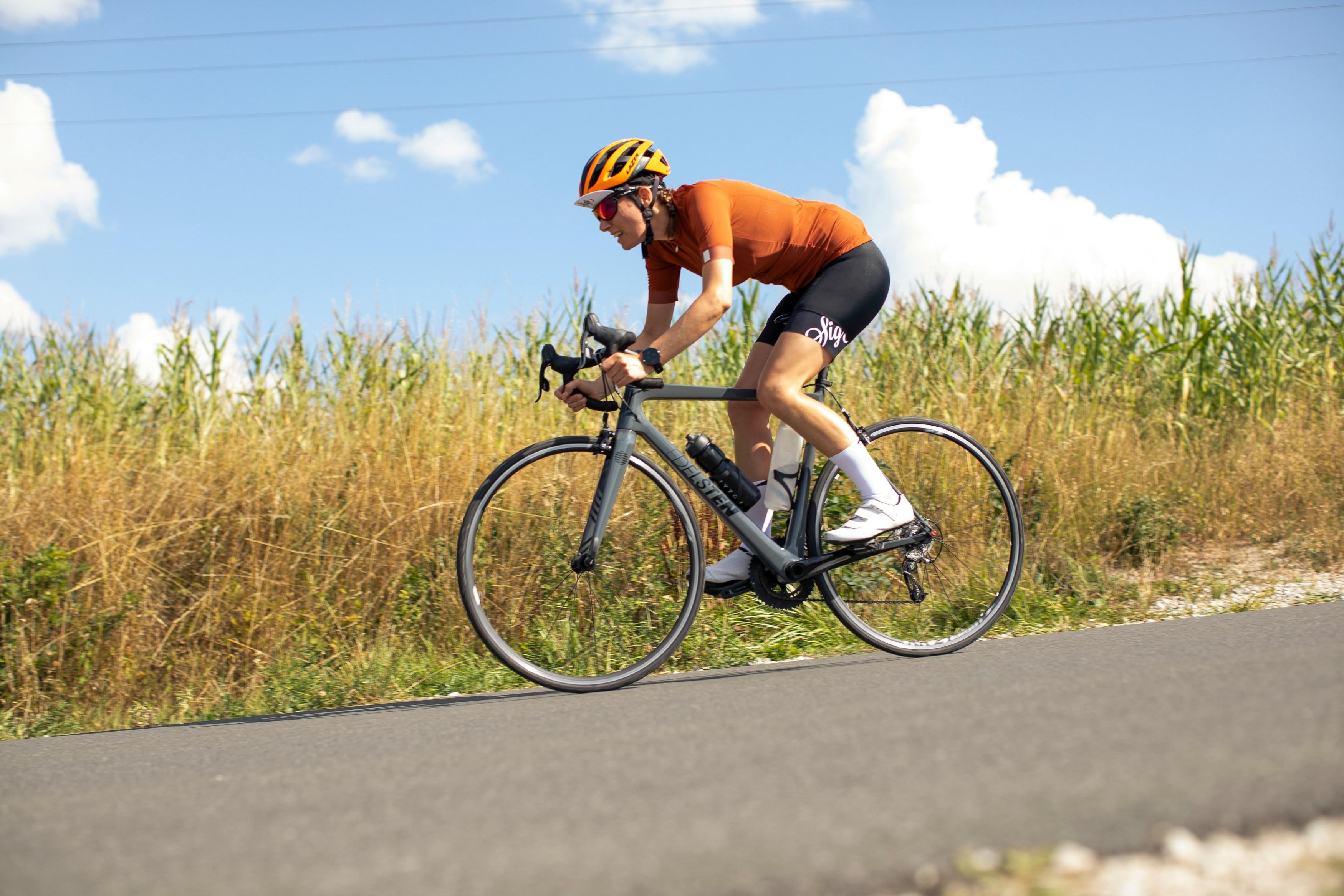 Cyclist riding a road bike outdoors in real conditions.
