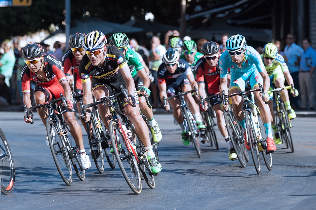 Group of road cyclists riding together outdoors on paved roads.