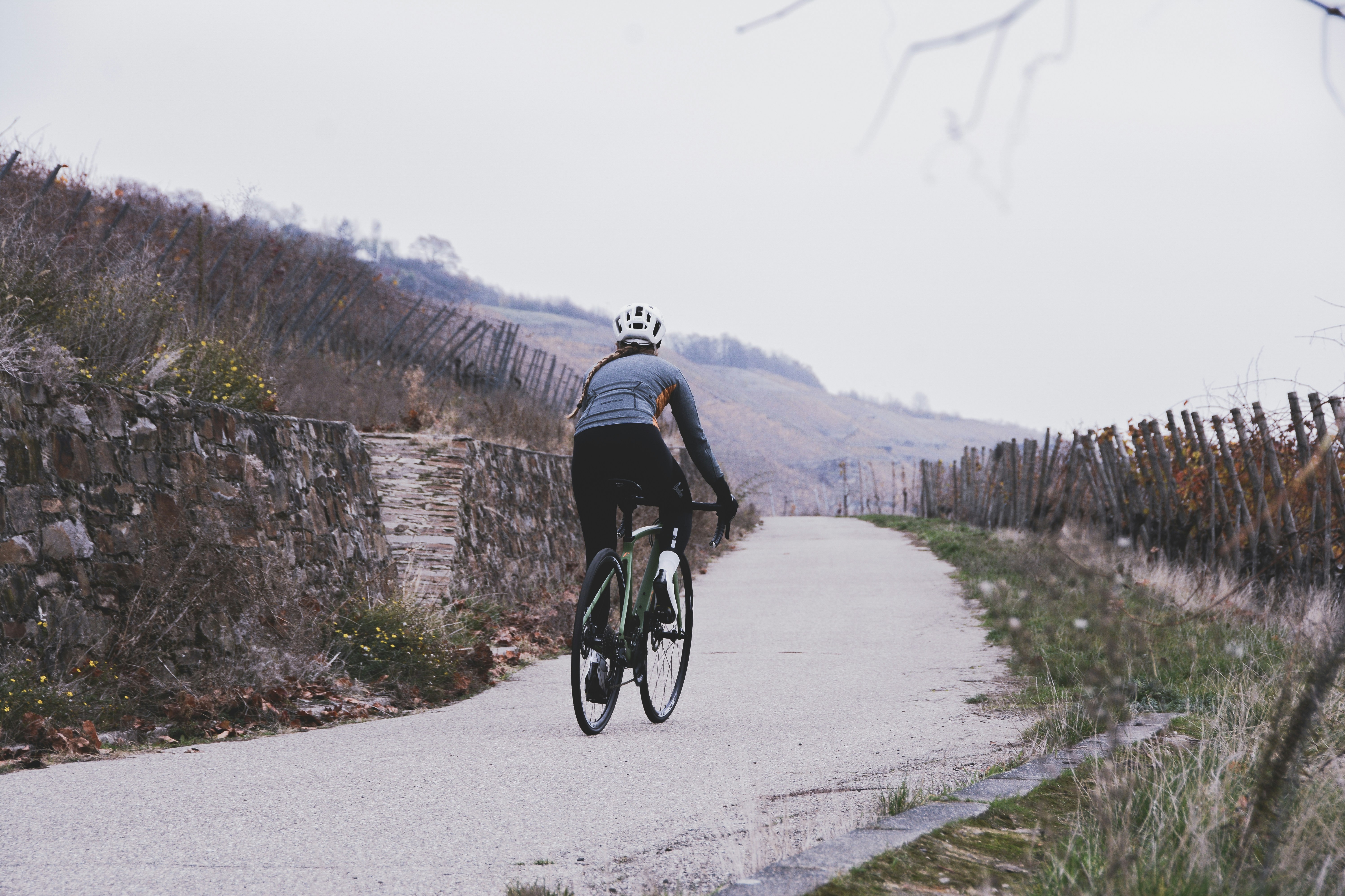 Cyclist riding a road bike outdoors in real conditions.