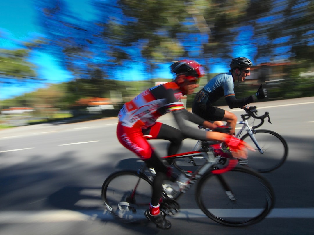 Group of road cyclists riding together outdoors on paved roads.