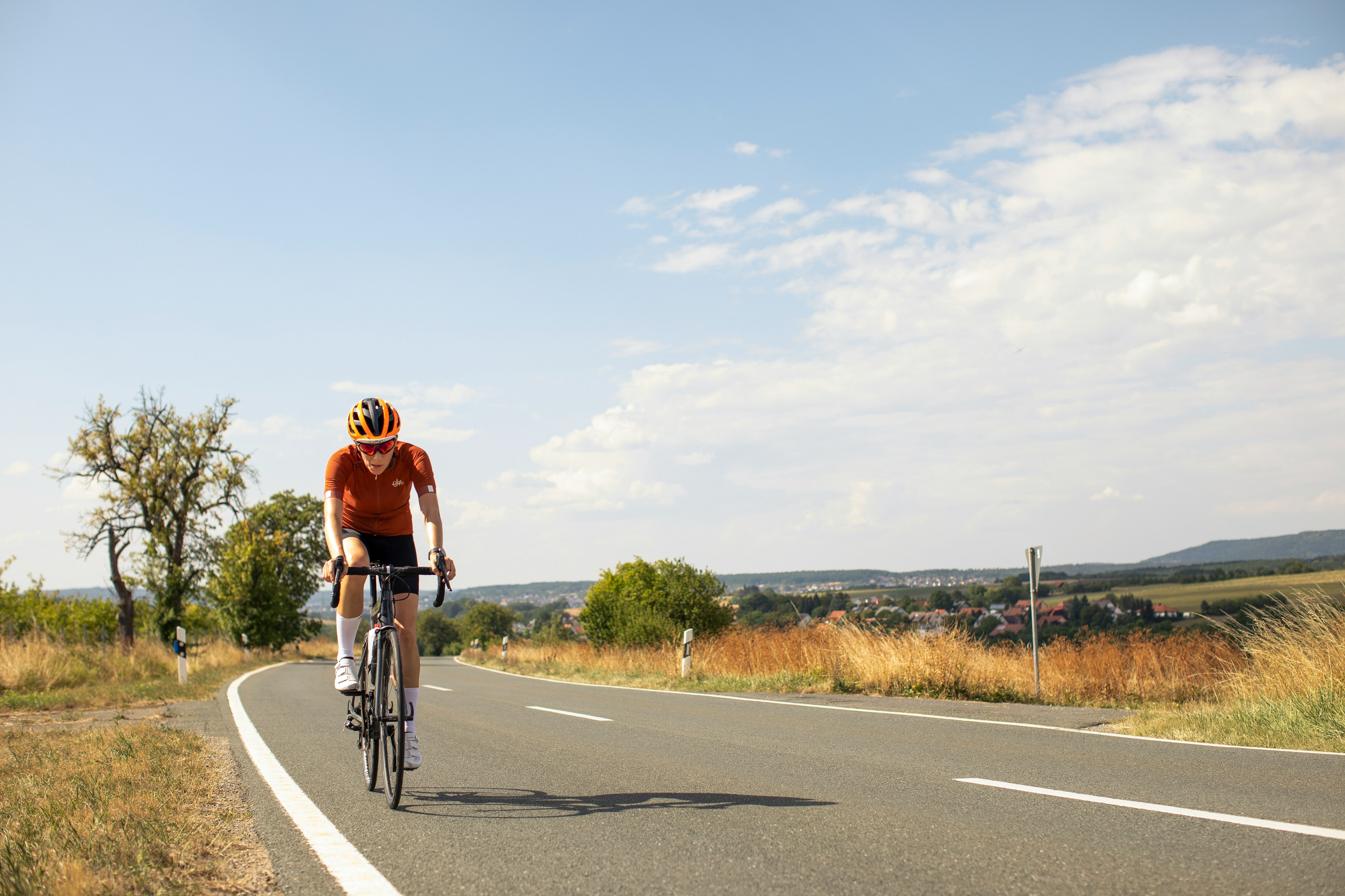 Cyclist riding a road bike outdoors in real conditions.
