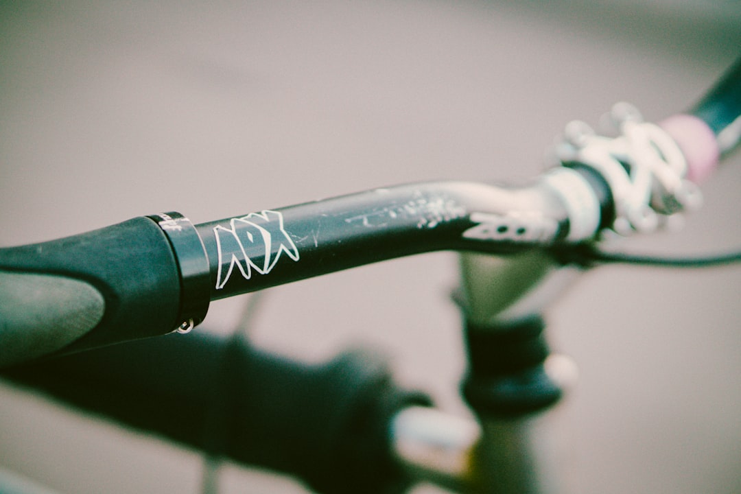 Close-up of a cyclist pedaling on a road bike with a power meter visible.