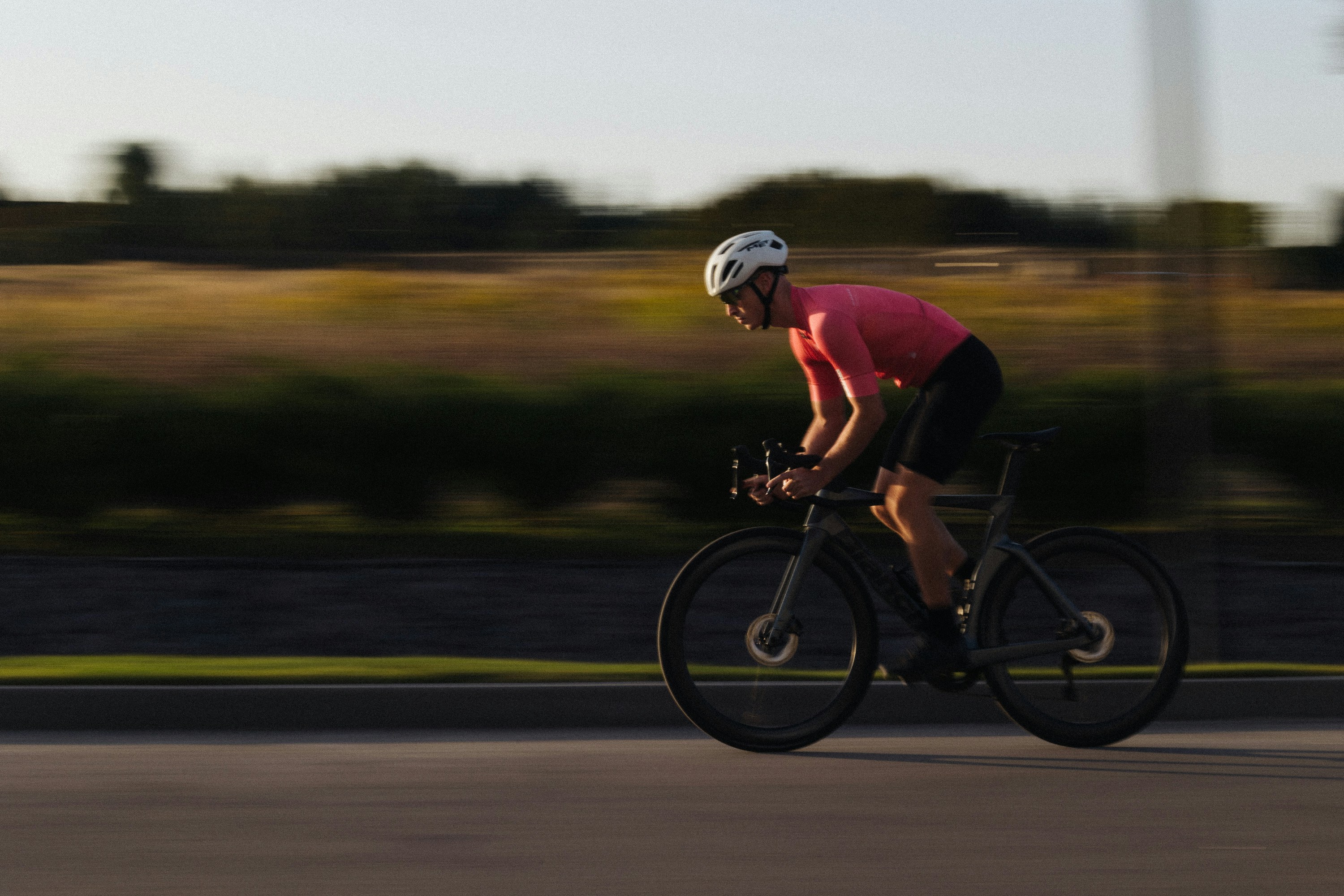 Cyclist riding a road bike outdoors in real conditions.