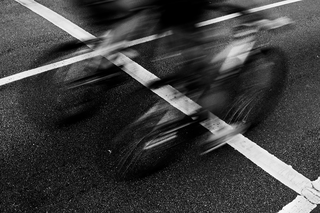 Group of road cyclists riding together outdoors on paved roads.