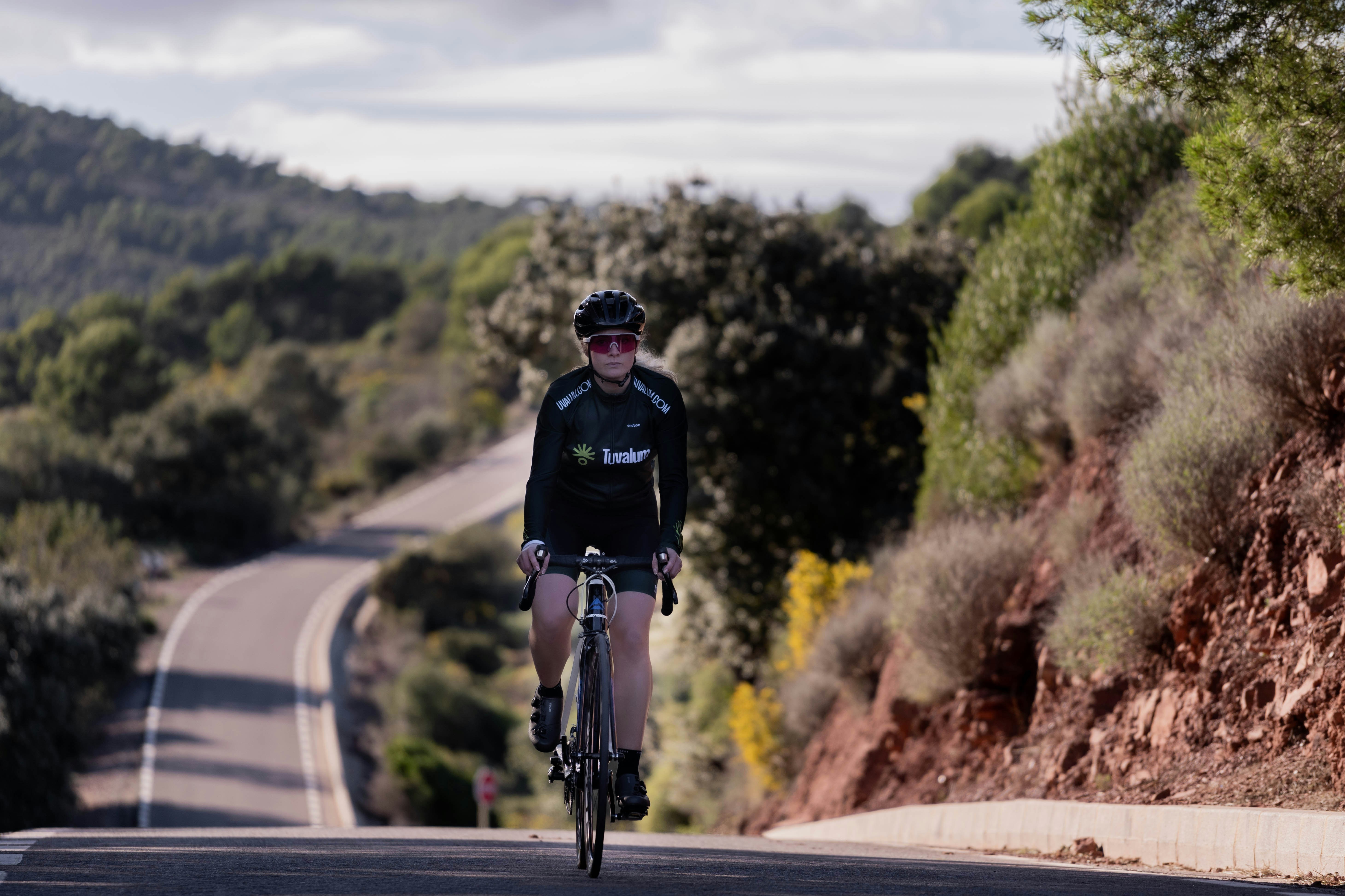 Cyclist riding a road bike outdoors in real conditions.