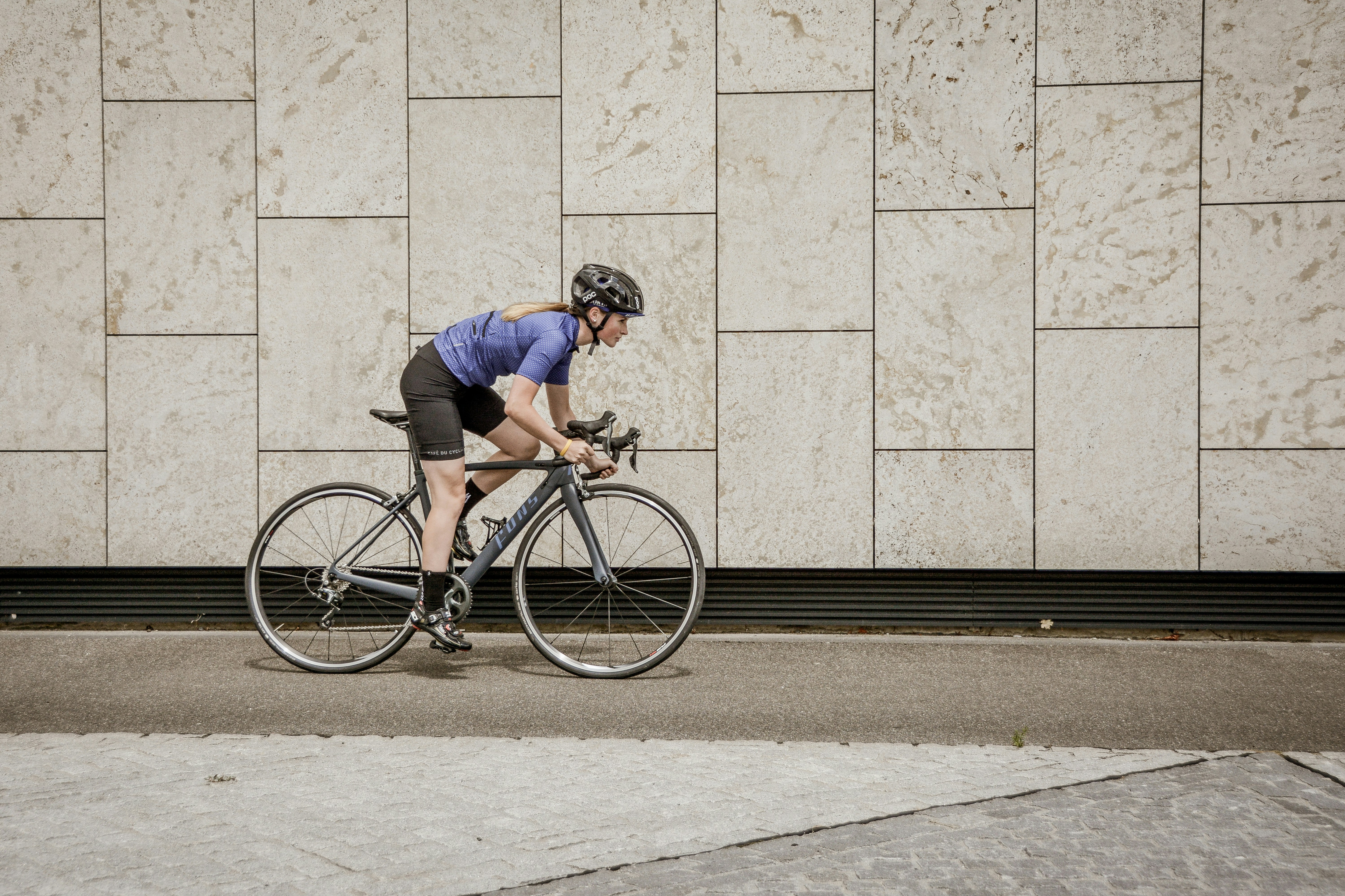 Cyclist riding a road bike outdoors in real conditions.
