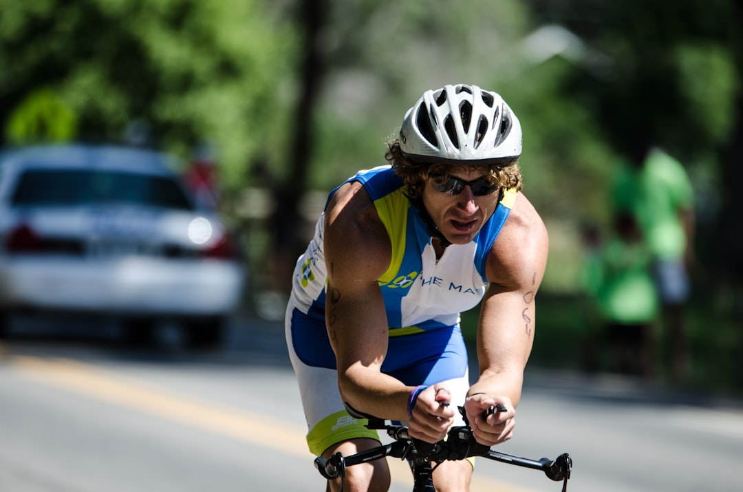 Close-up of a cyclist pedaling on a road bike with a power meter visible.