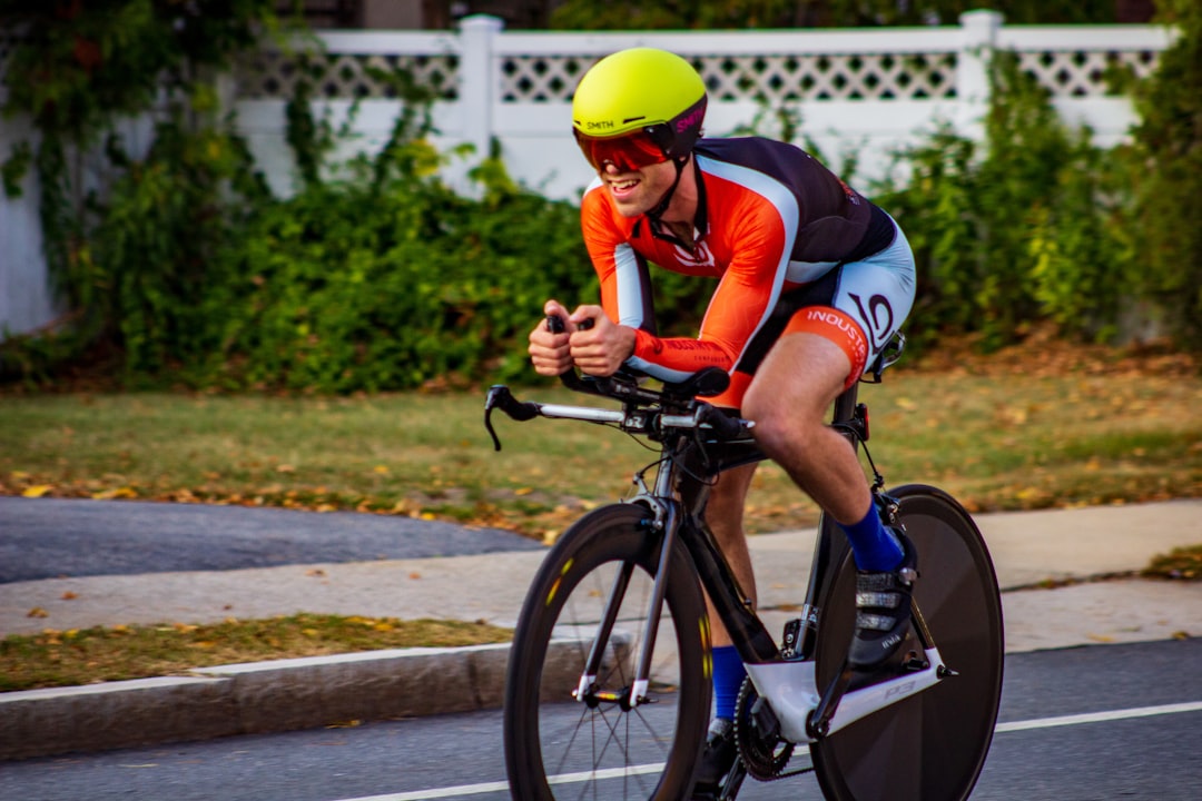 Close-up of a cyclist pedaling on a road bike with a power meter visible.