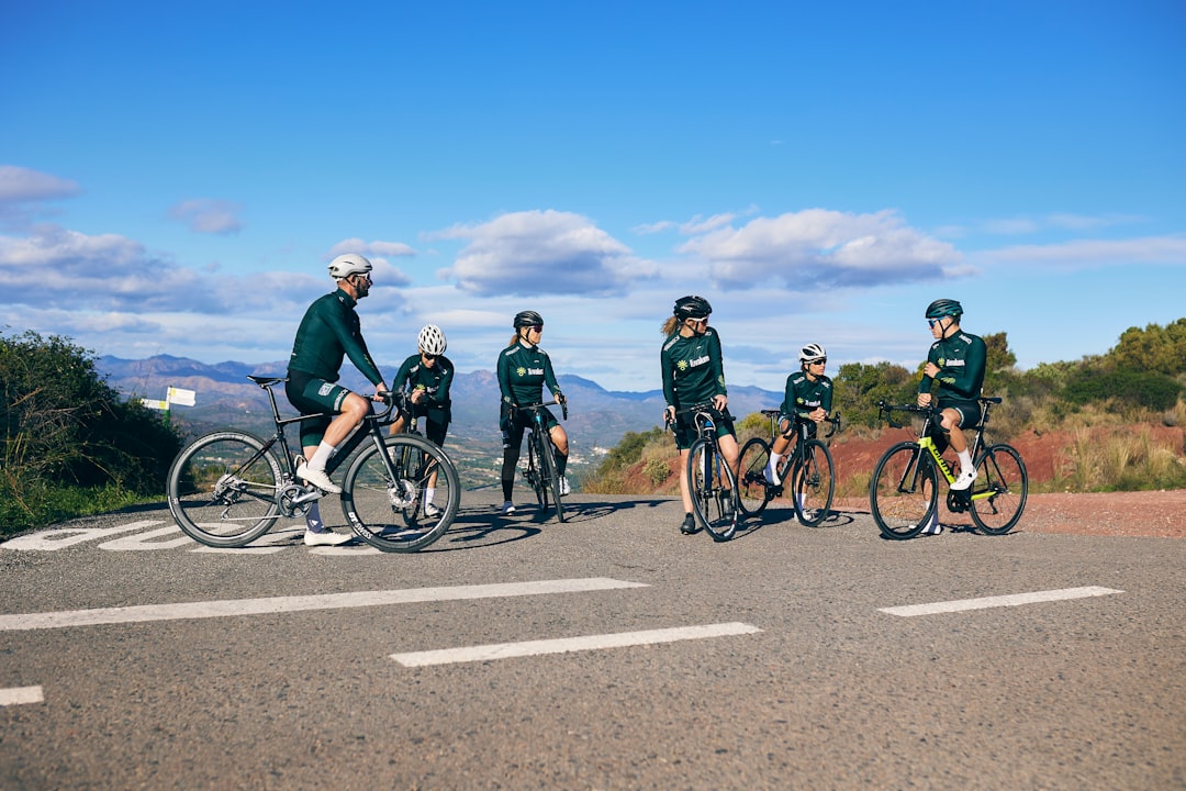Group of road cyclists riding together outdoors on paved roads.