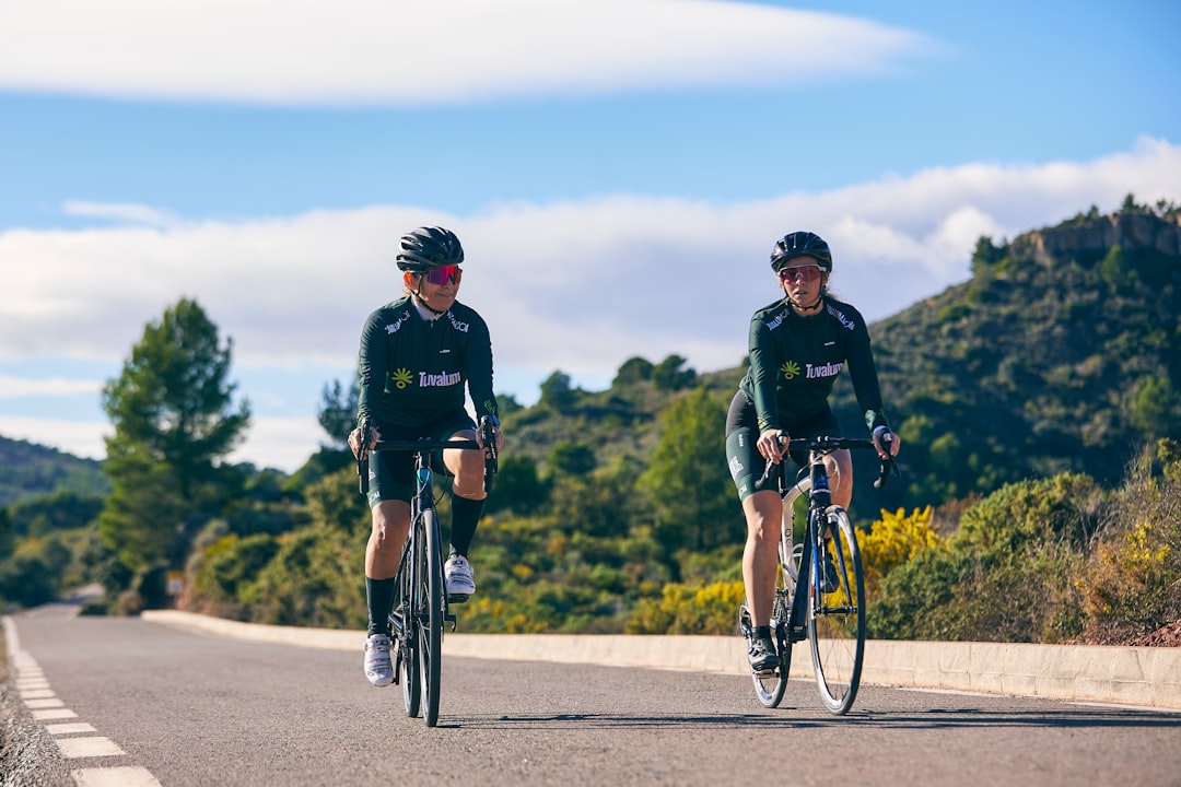 Group of road cyclists riding together outdoors on paved roads.