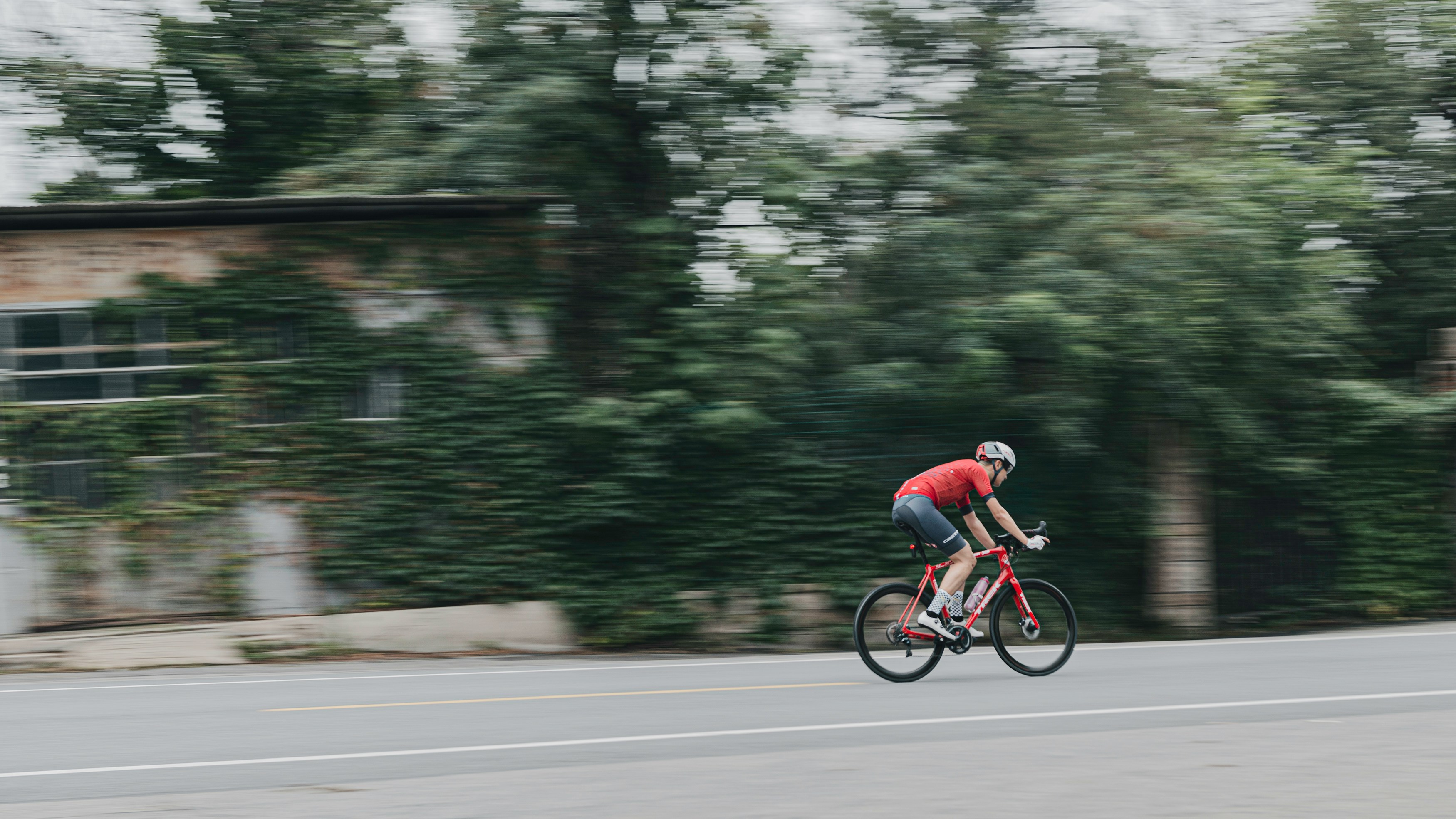 Cyclist riding a road bike outdoors in real conditions.