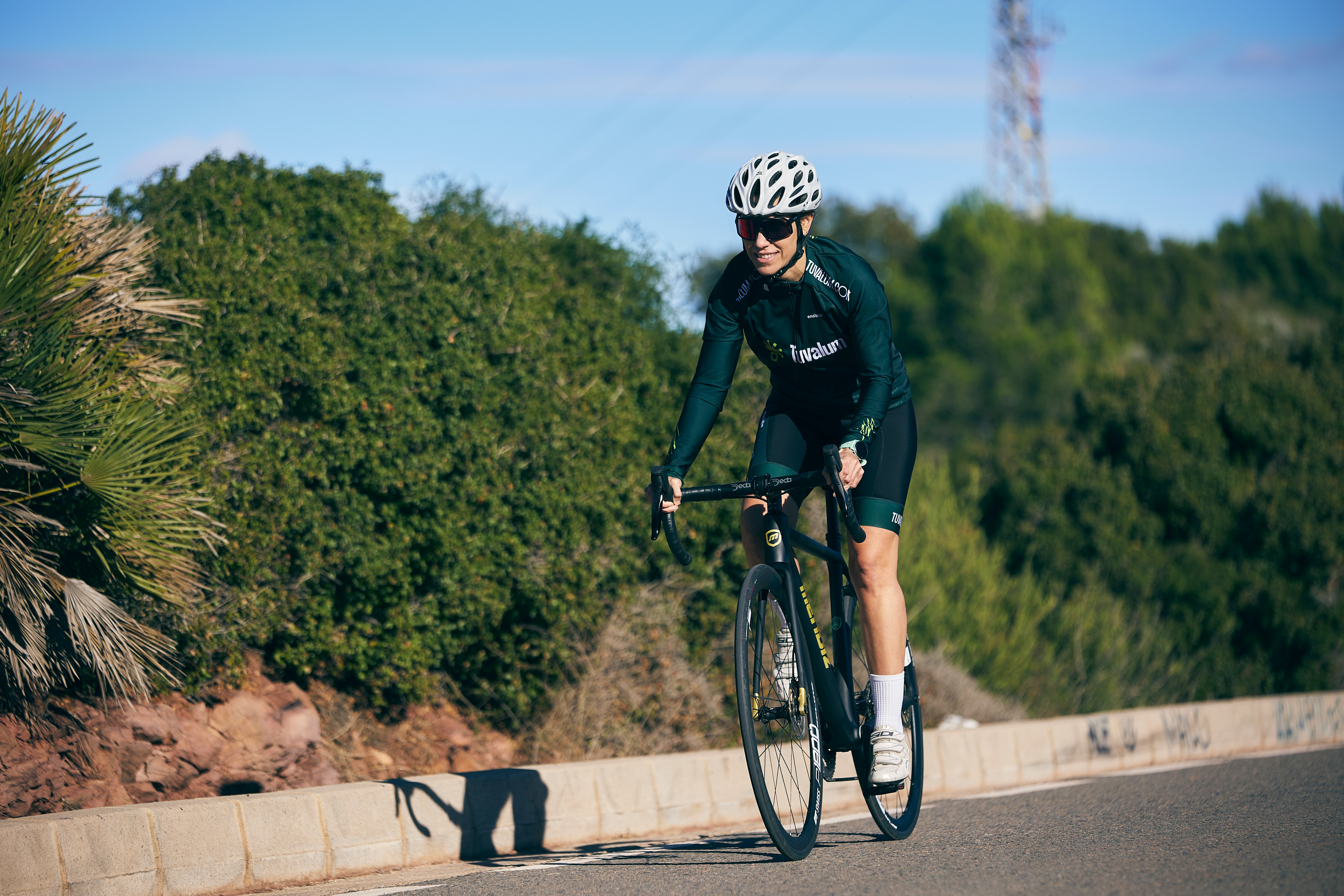 Cyclist riding a road bike outdoors in real conditions.