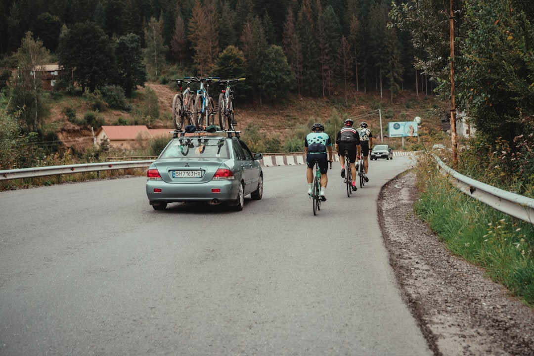 Group of road cyclists riding together outdoors on paved roads.