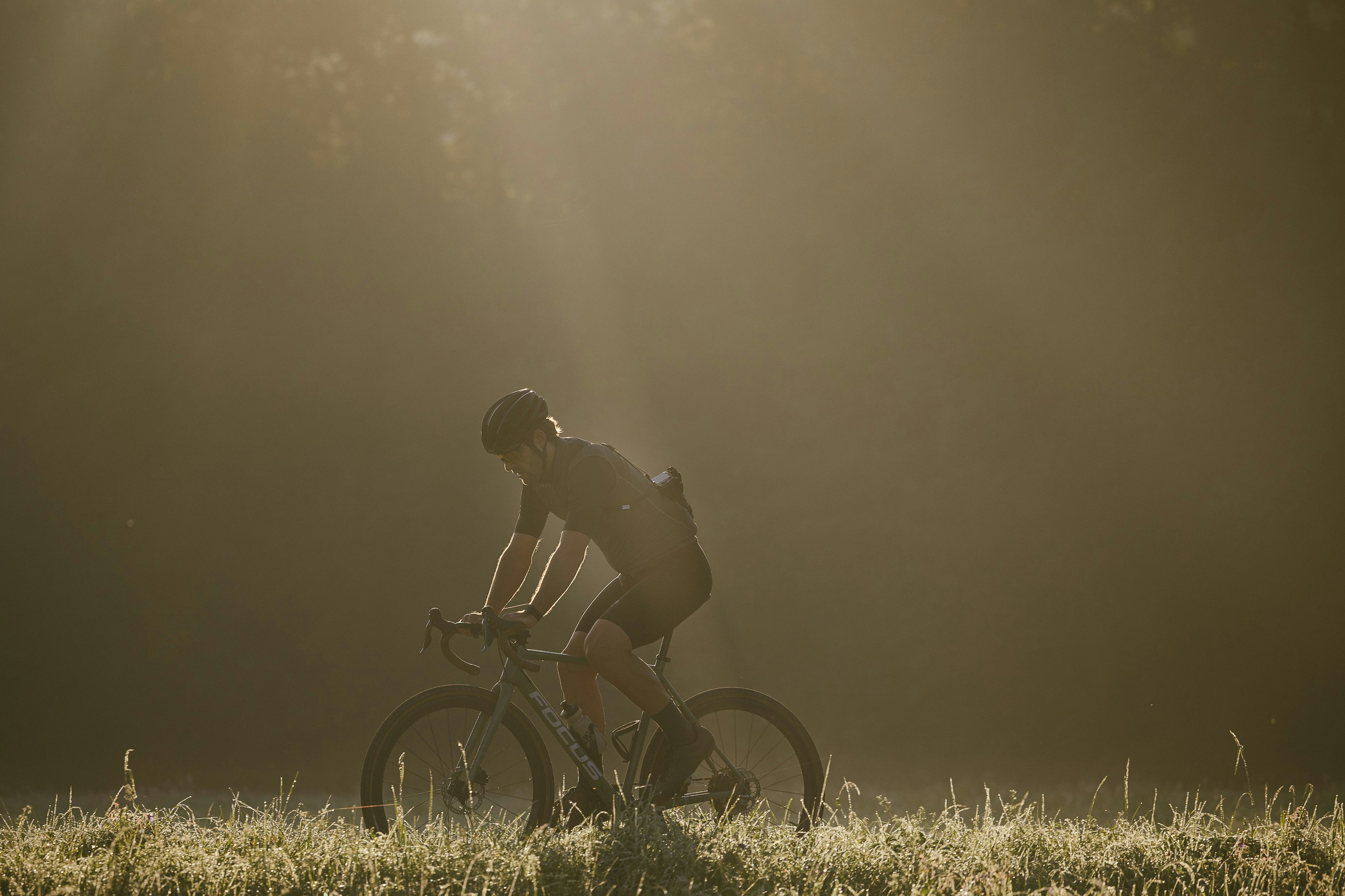 Cyclist riding a road bike outdoors in real conditions.