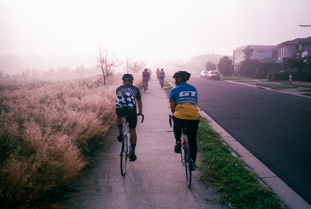 Group of road cyclists riding together outdoors on paved roads.