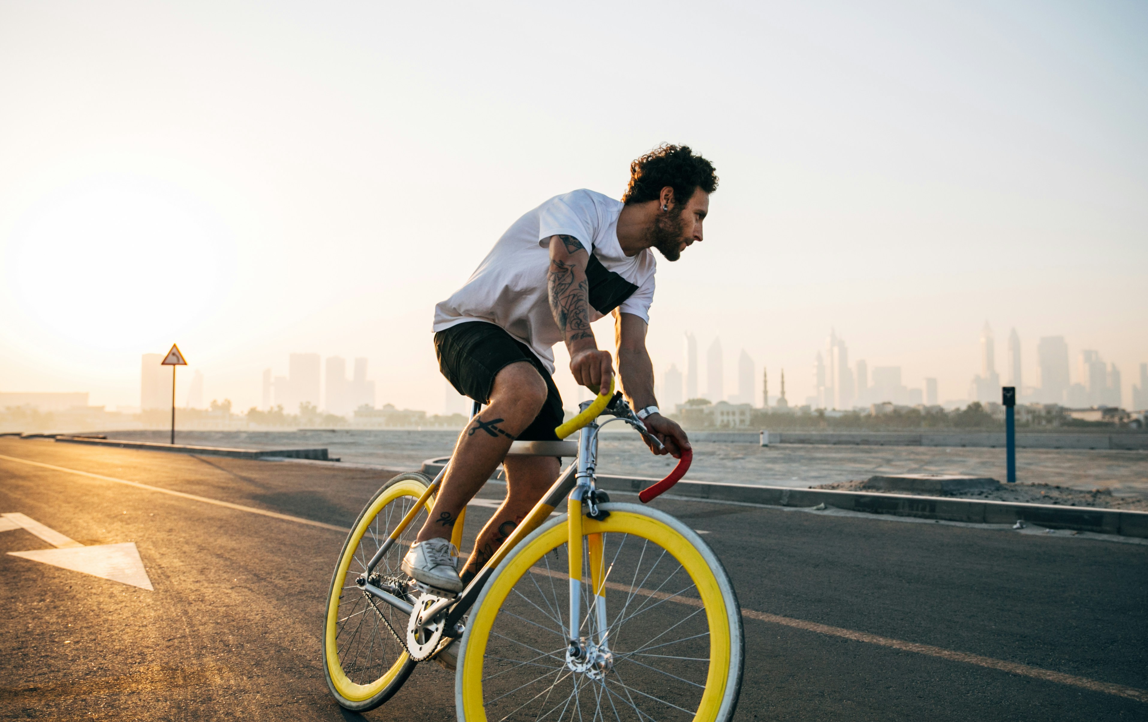 Cyclist riding a road bike outdoors in real conditions.