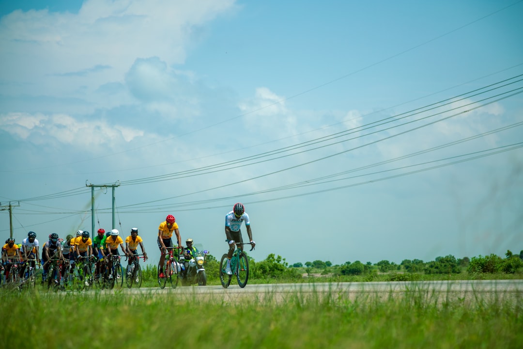 Group of road cyclists riding together outdoors on paved roads.