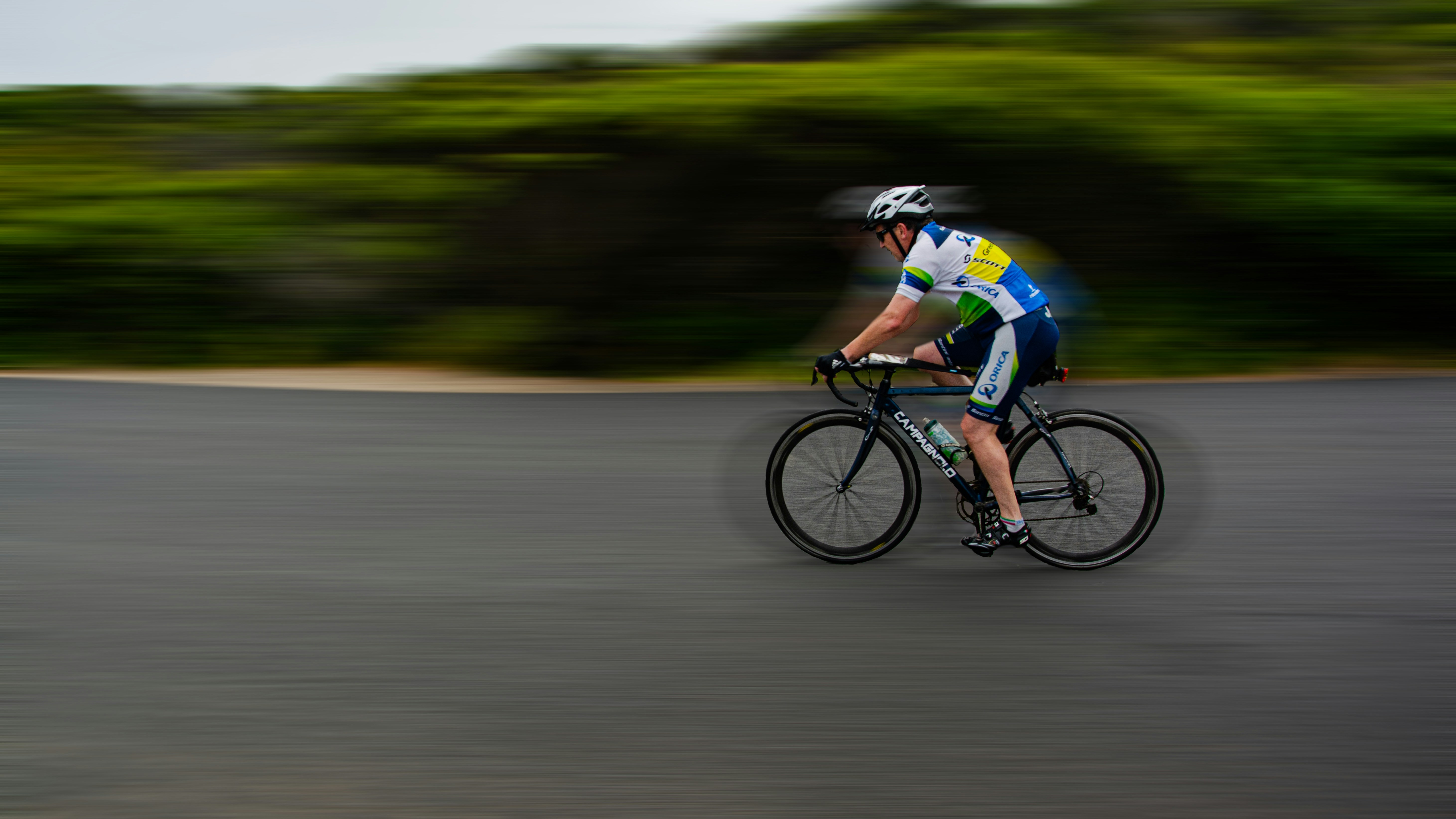Cyclist riding a road bike outdoors in real conditions.