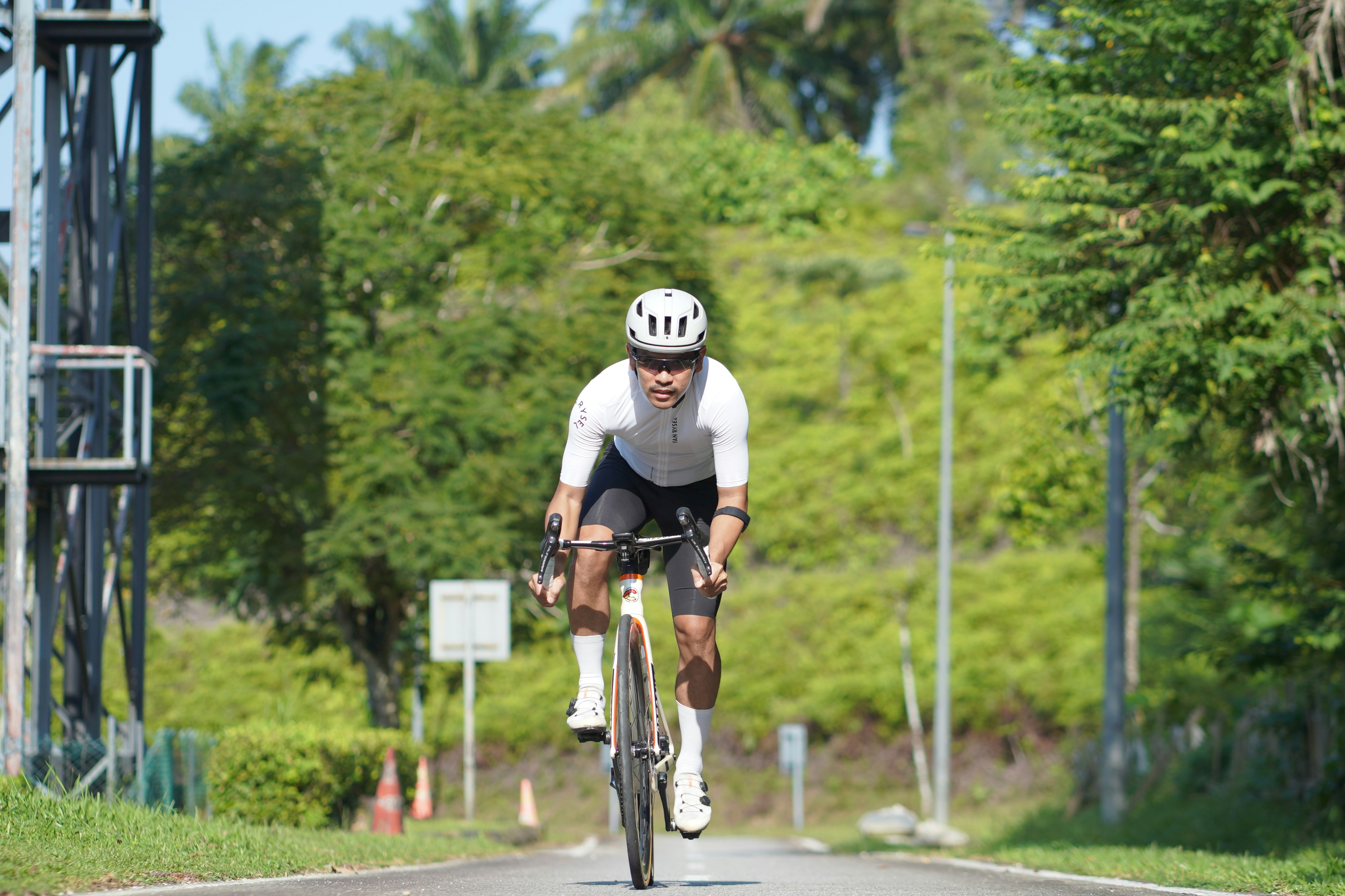 Cyclist riding a road bike outdoors in real conditions.