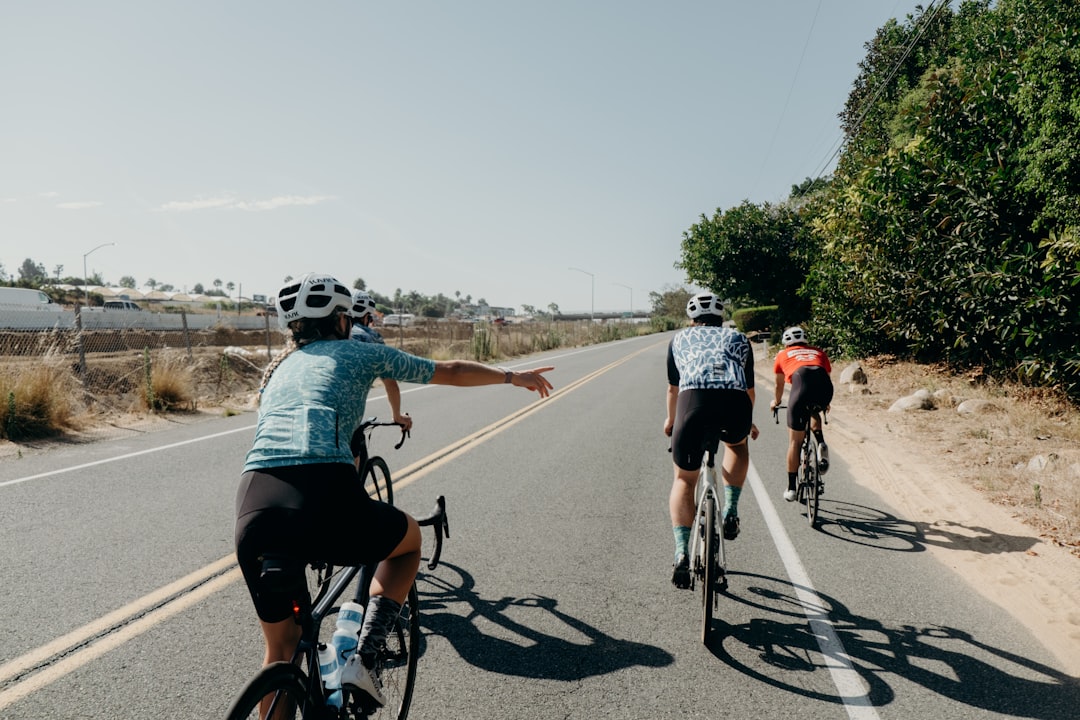 Group of road cyclists riding together outdoors on paved roads.