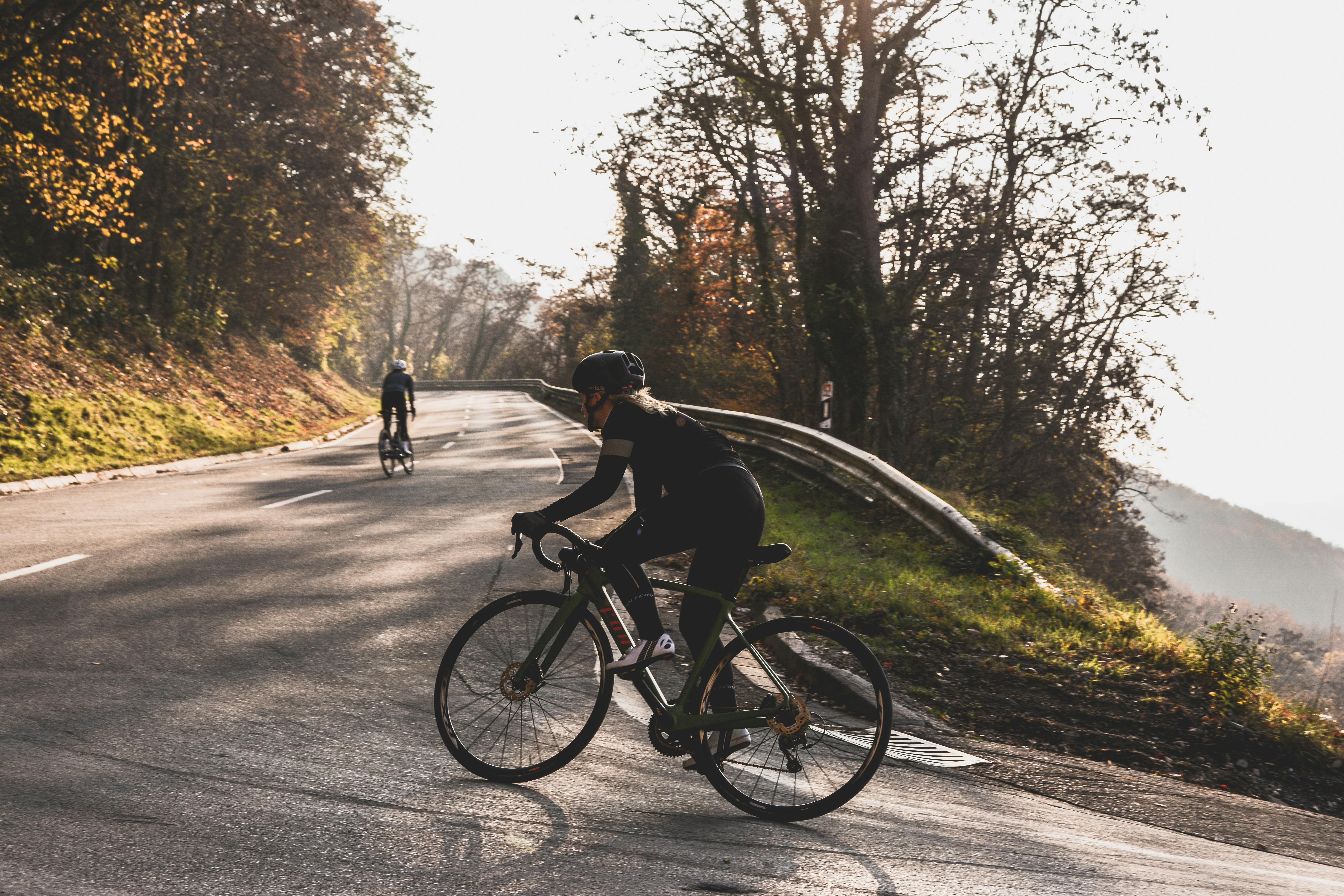 Cyclist riding a road bike outdoors in real conditions.