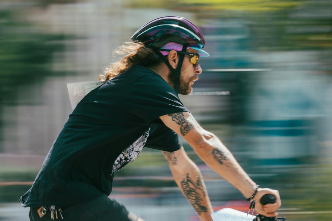Close-up of a cyclist pedaling on a road bike with a power meter visible.