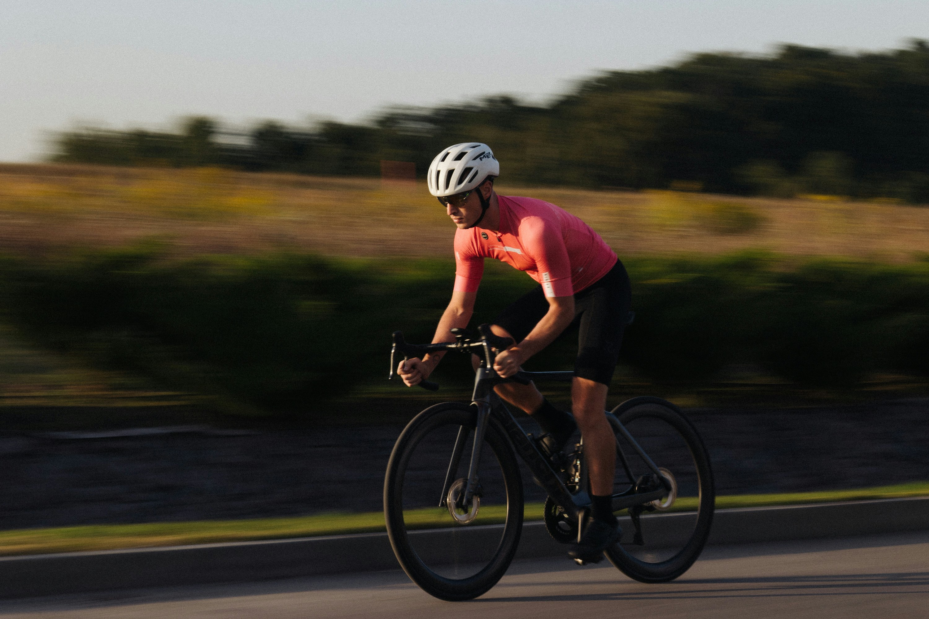 Cyclist riding a road bike outdoors in real conditions.