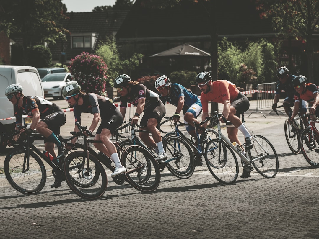 Group of road cyclists riding together outdoors on paved roads.