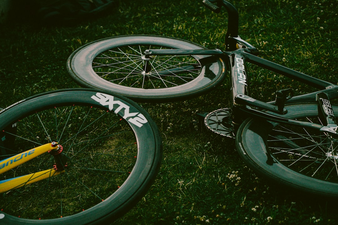 Close-up of a cyclist pedaling on a road bike with a power meter visible.