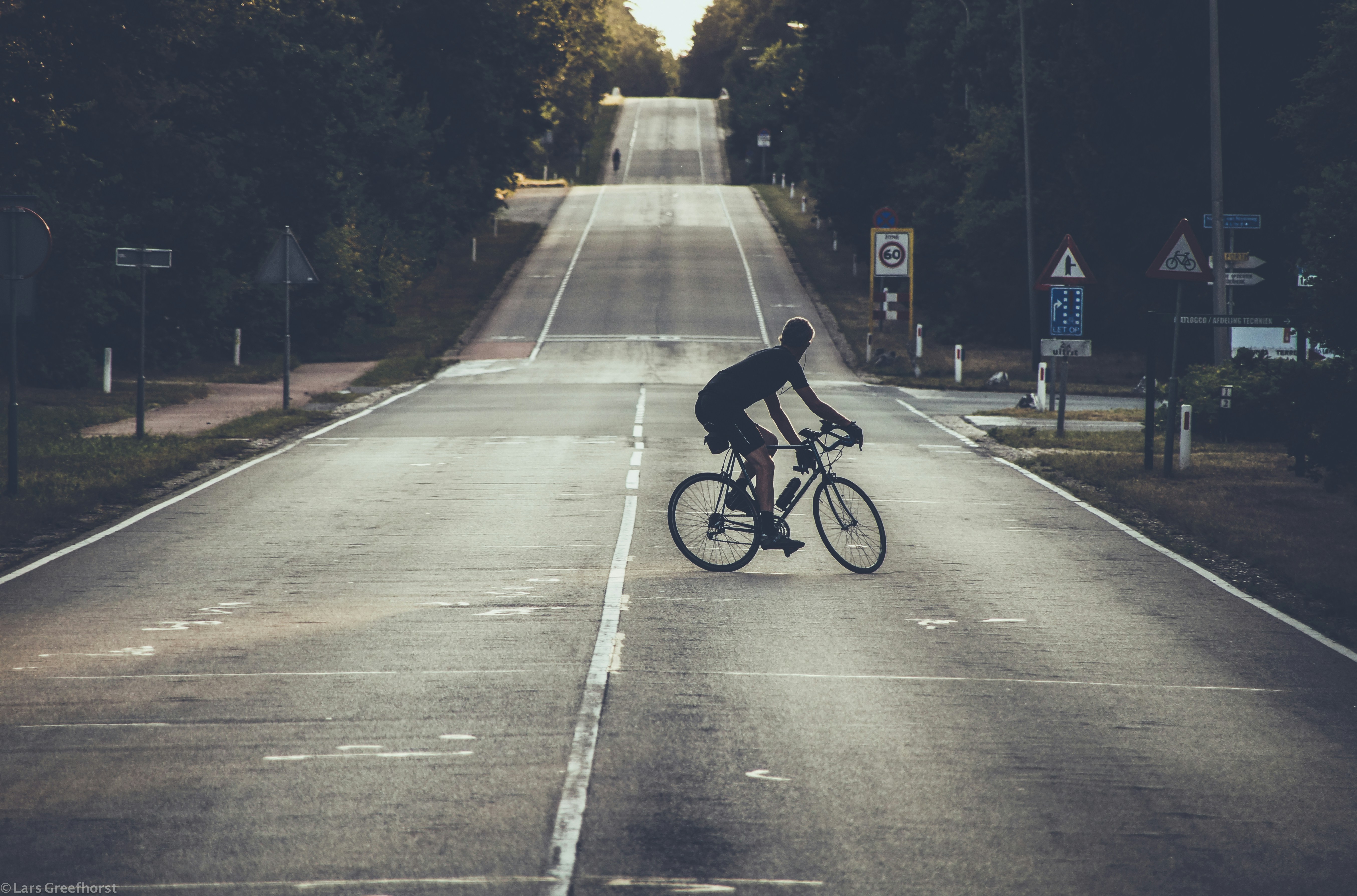 Cyclist riding a road bike outdoors in real conditions.
