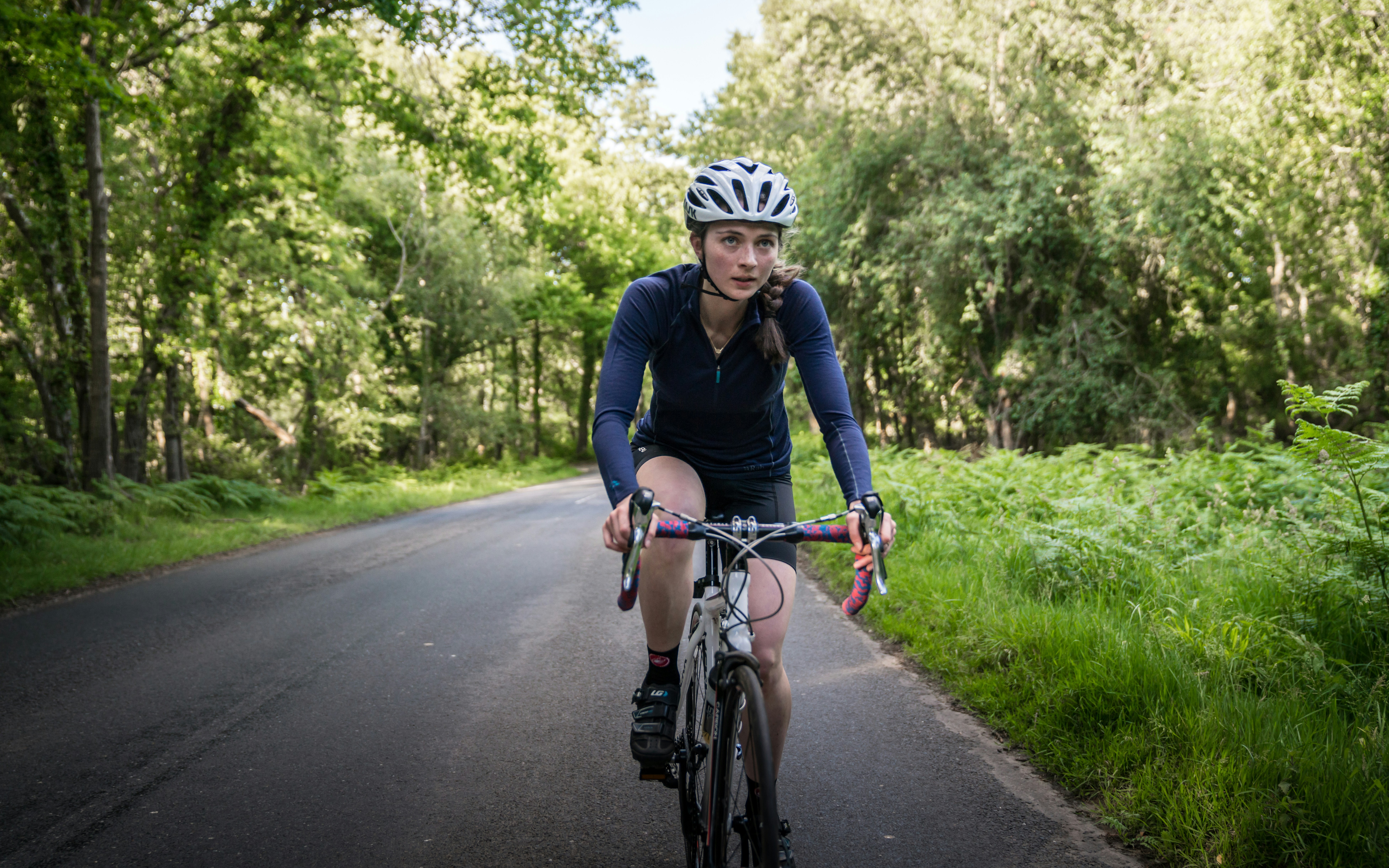 Cyclist riding a road bike outdoors in real conditions.