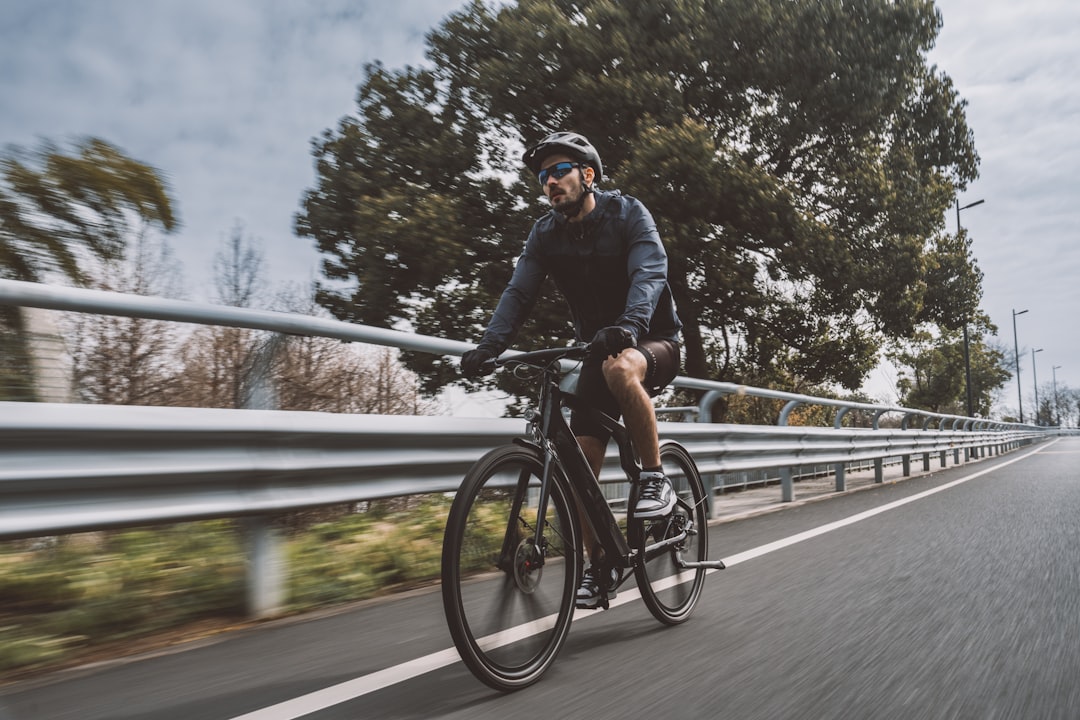 Group of road cyclists riding together outdoors on paved roads.