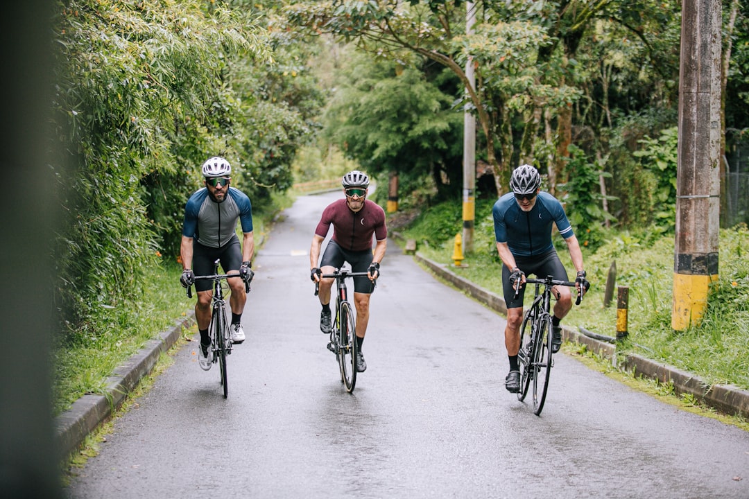 Group of road cyclists riding together outdoors on paved roads.