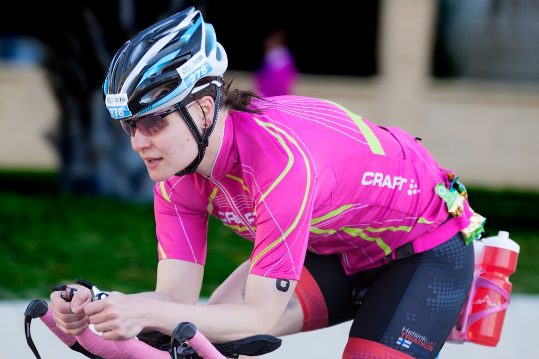 Close-up of a cyclist pedaling on a road bike with a power meter visible.