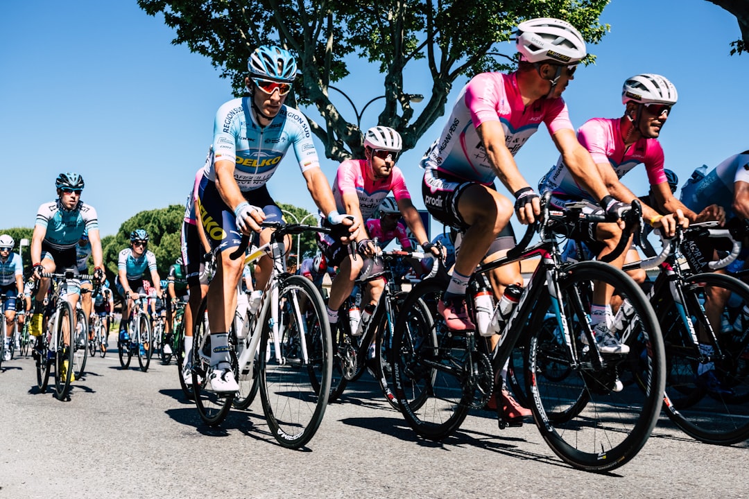 Group of road cyclists riding together outdoors on paved roads.