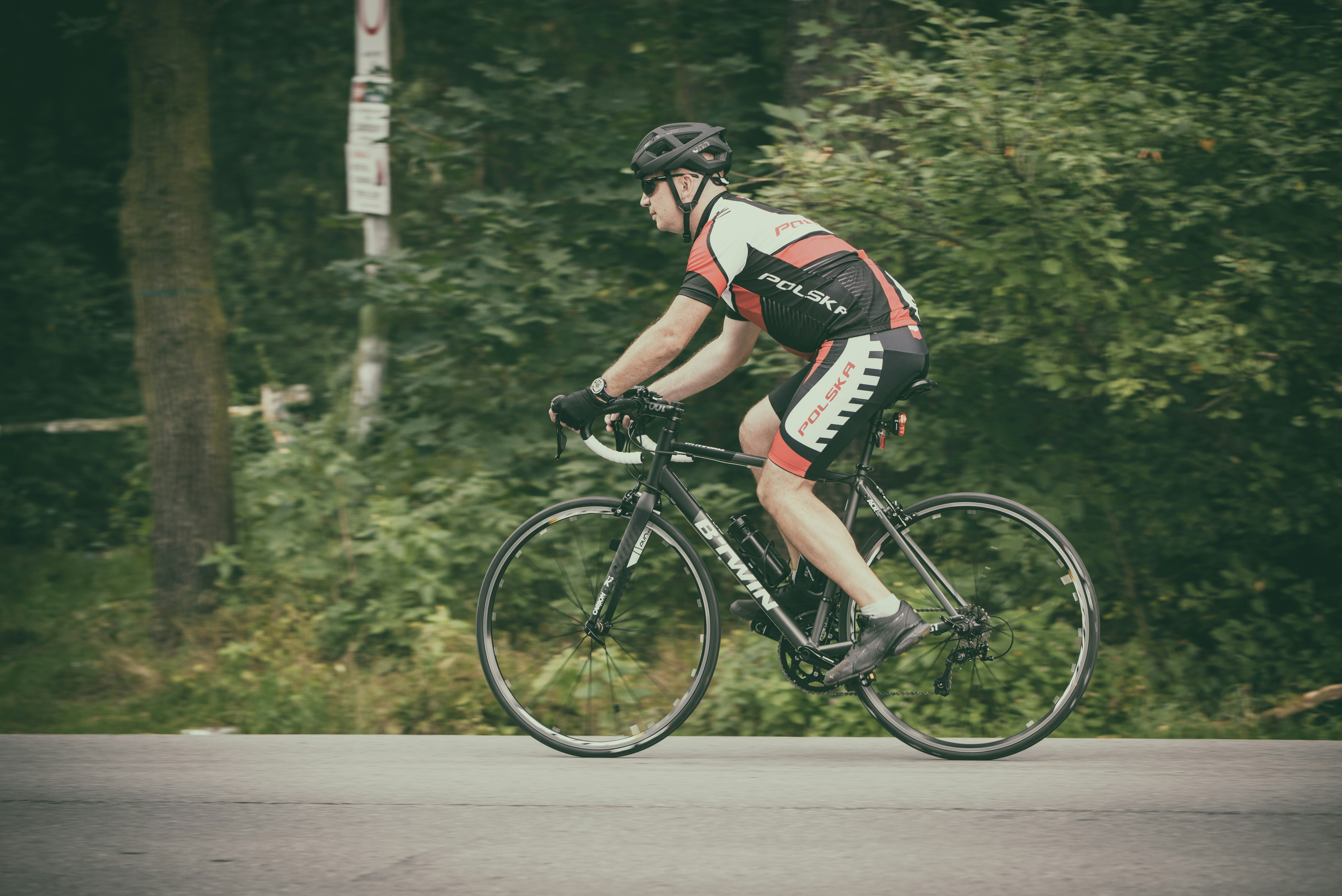 Cyclist riding a road bike outdoors in real conditions.