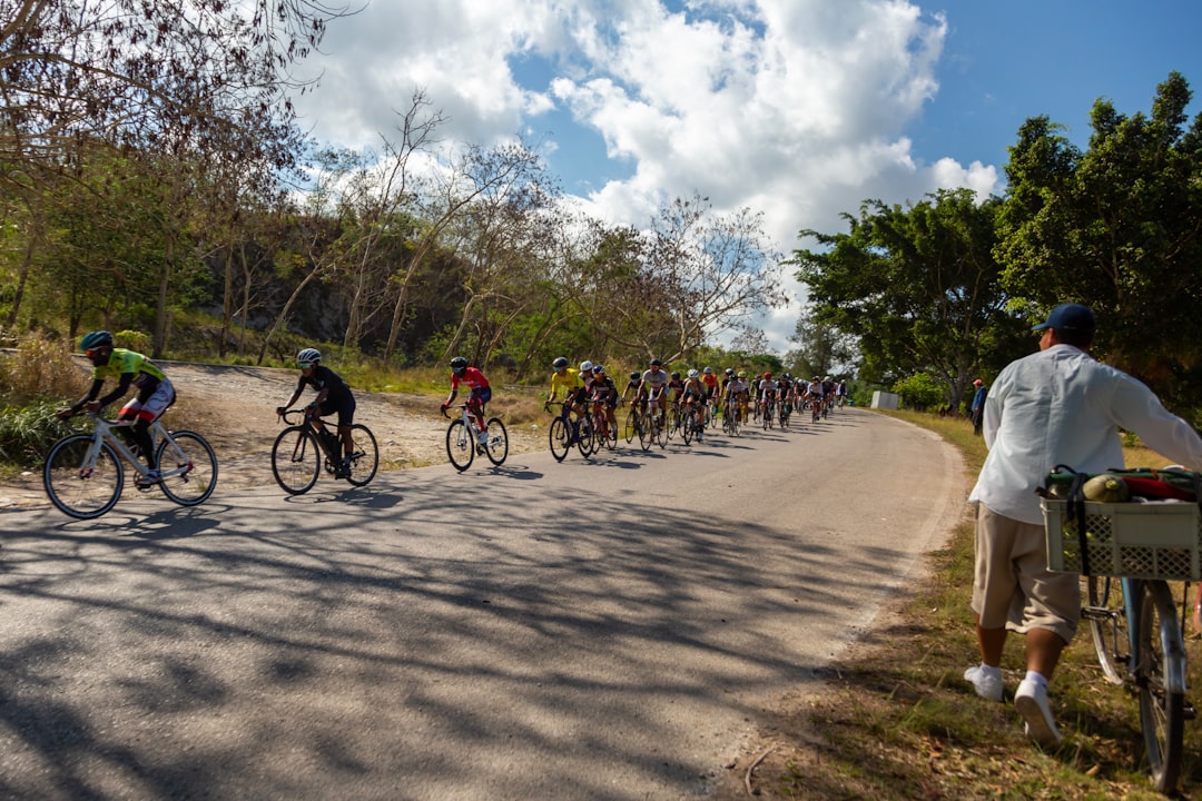 Group of road cyclists riding together outdoors on paved roads.