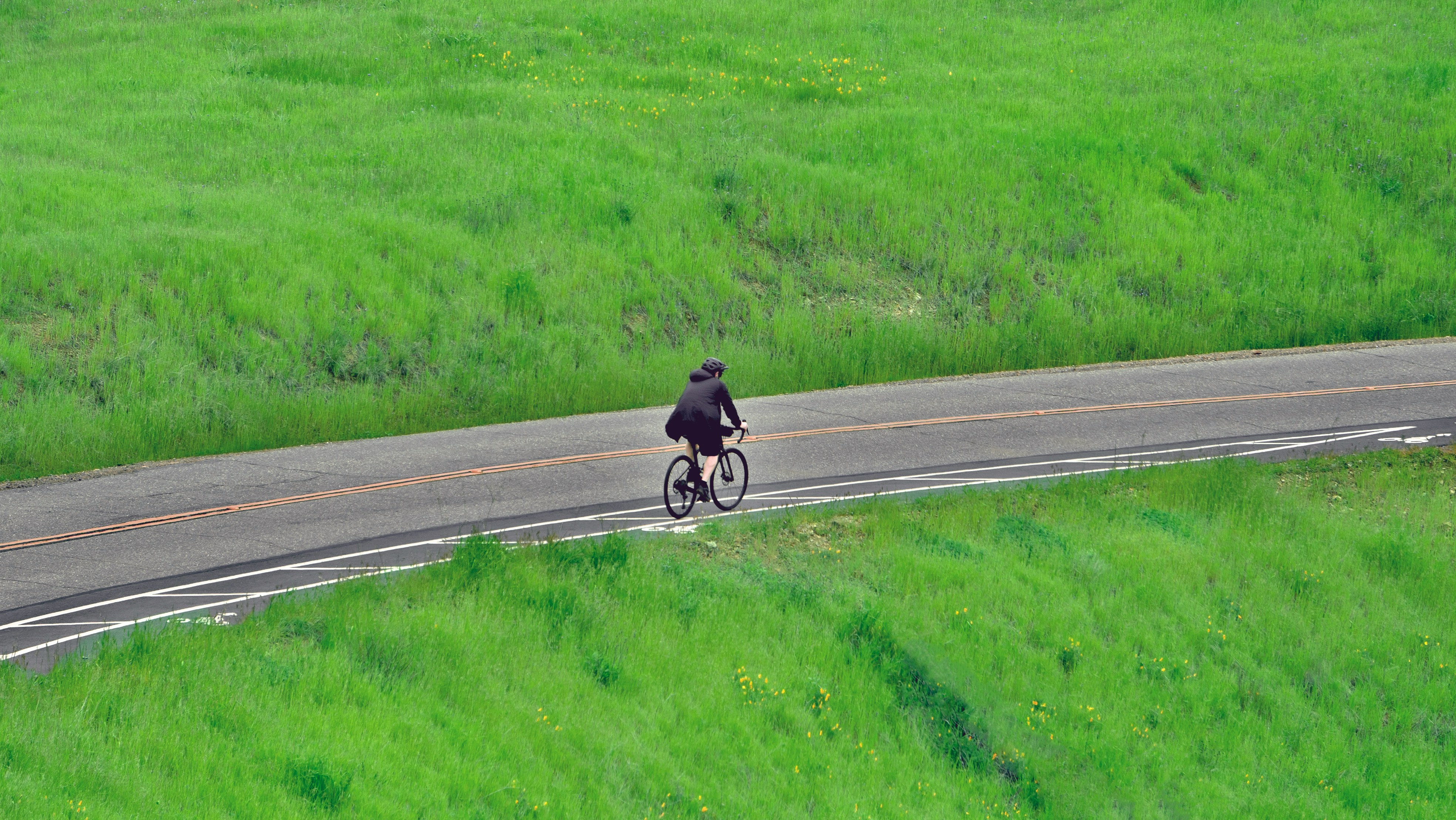 Cyclist riding a road bike outdoors in real conditions.