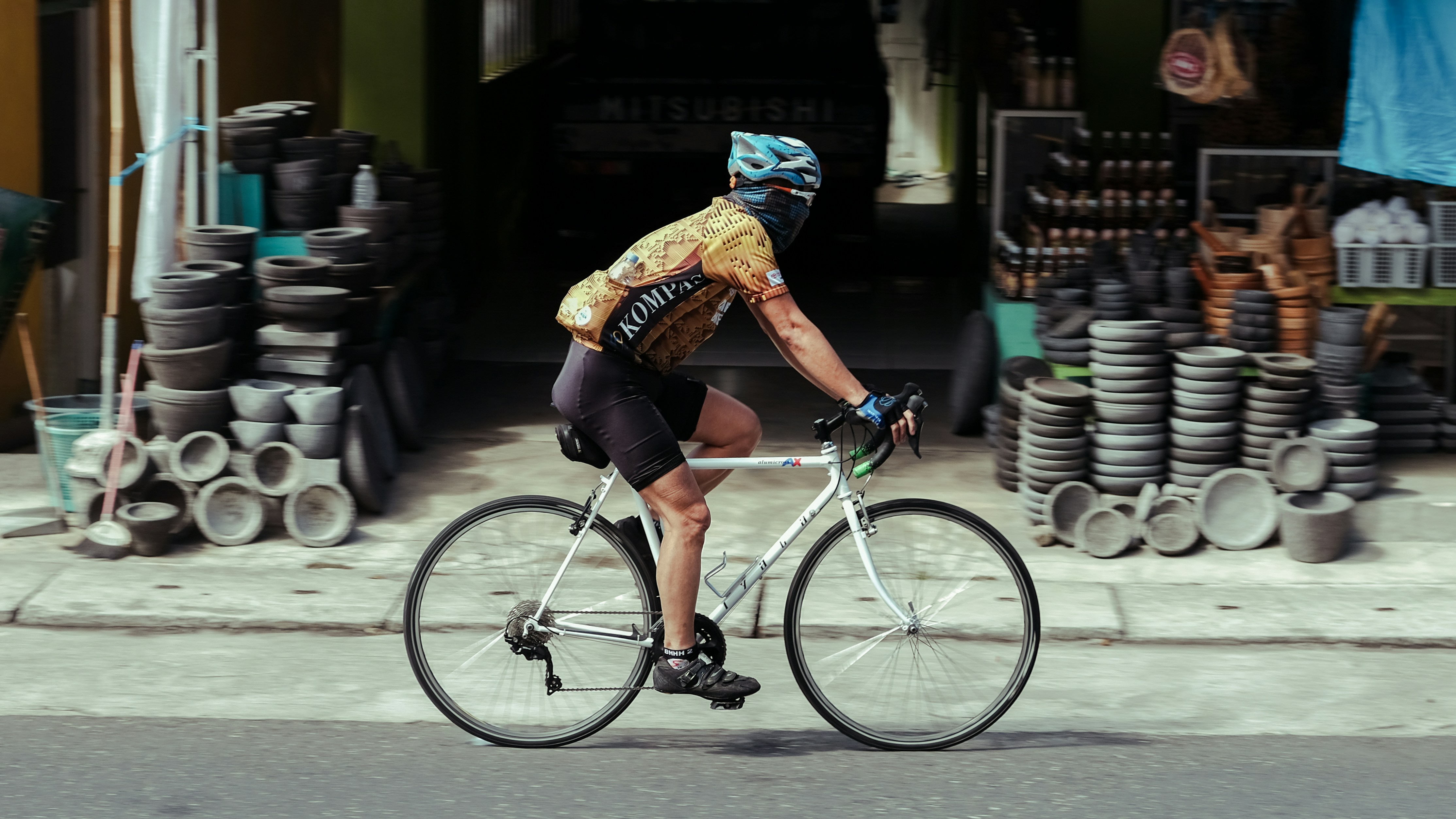 Cyclist riding a road bike outdoors in real conditions.