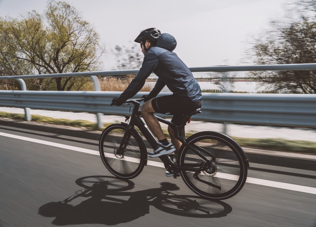 Group of road cyclists riding together outdoors on paved roads.