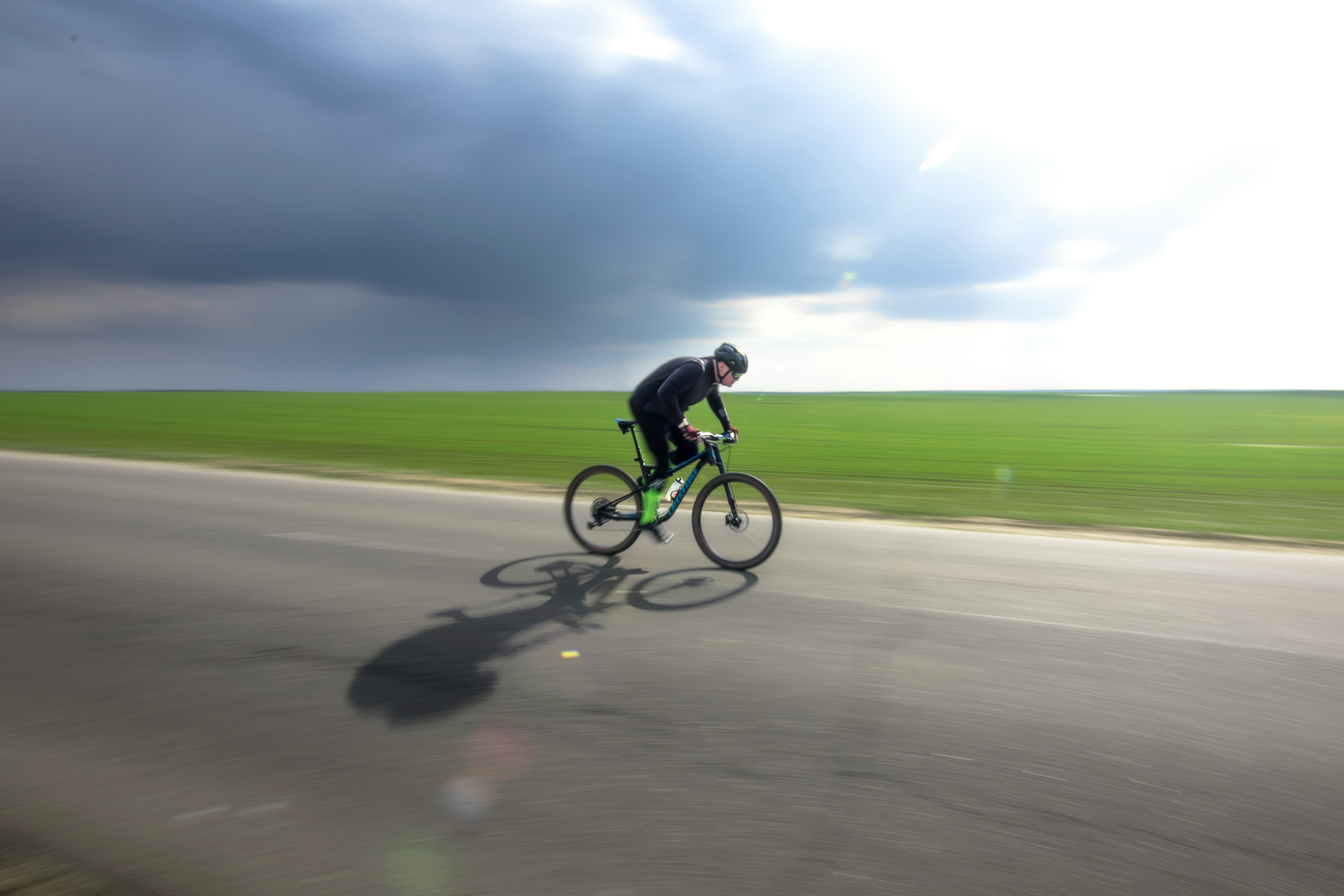 Cyclist riding a road bike outdoors in real conditions.
