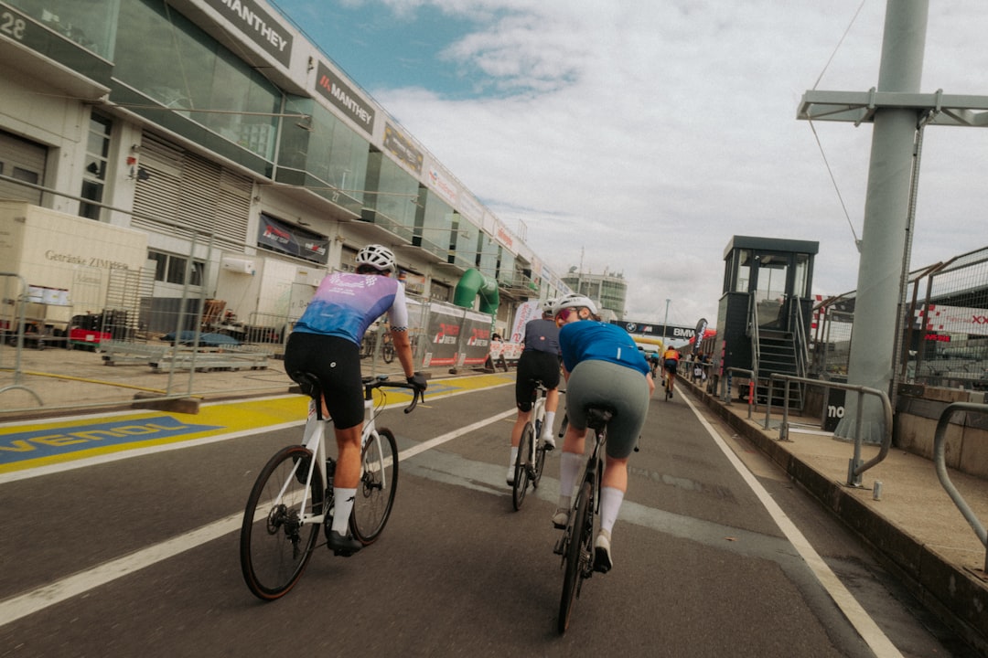 Group of road cyclists riding together outdoors on paved roads.